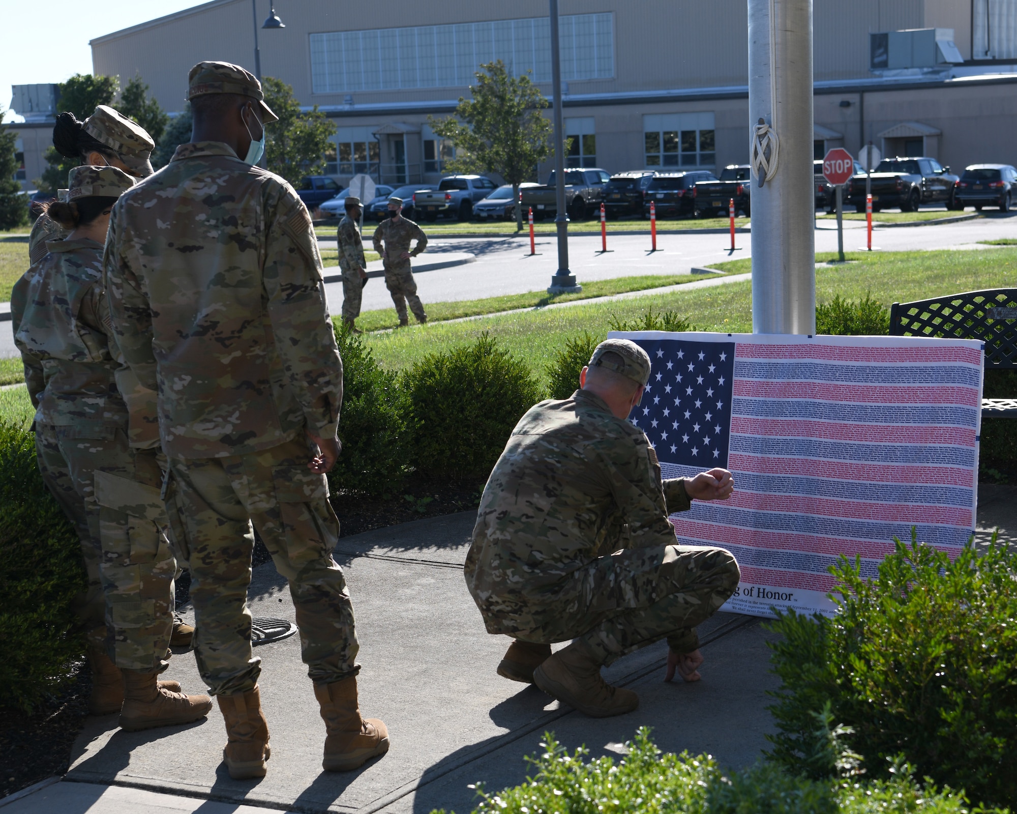 Airmen from the 106th Rescue Wing assigned to the New York National Guard pay tribute to 9/11 victims on the Flag of Honor, September 11, 2021, at Gabreski Air National Guard Base in Westhampton Beach, N.Y. The Flag of Honor, comprised of the names of those who died in the terror attacks on 9/11 and in the 1993 World Trade Center bombing, was on display during the 20th anniversary of 9/11. (U.S. Air National Guard photo by Senior Airman Kevin J. Donaldson)