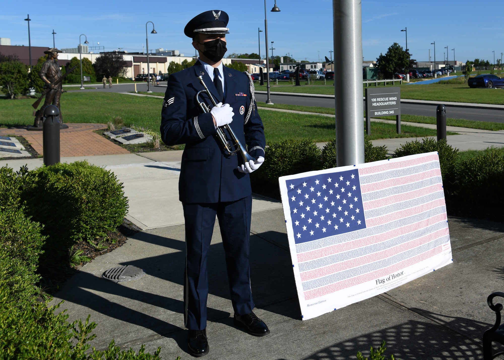 Senior Airman Allen Bethancourt, a 106th personnelist and Honor Guard member, poses with the Flag of Honor, September 11, 2021, at Gabreski Air National Guard Base in Westhampton Beach, N.Y. The Flag of Honor, comprised of the names of those who died in the terror attacks on 9/11 and in the 1993 World Trade Center bombing, was on display during the 20th anniversary of 9/11. (U.S. Air National Guard photo by Senior Airman Kevin J. Donaldson)