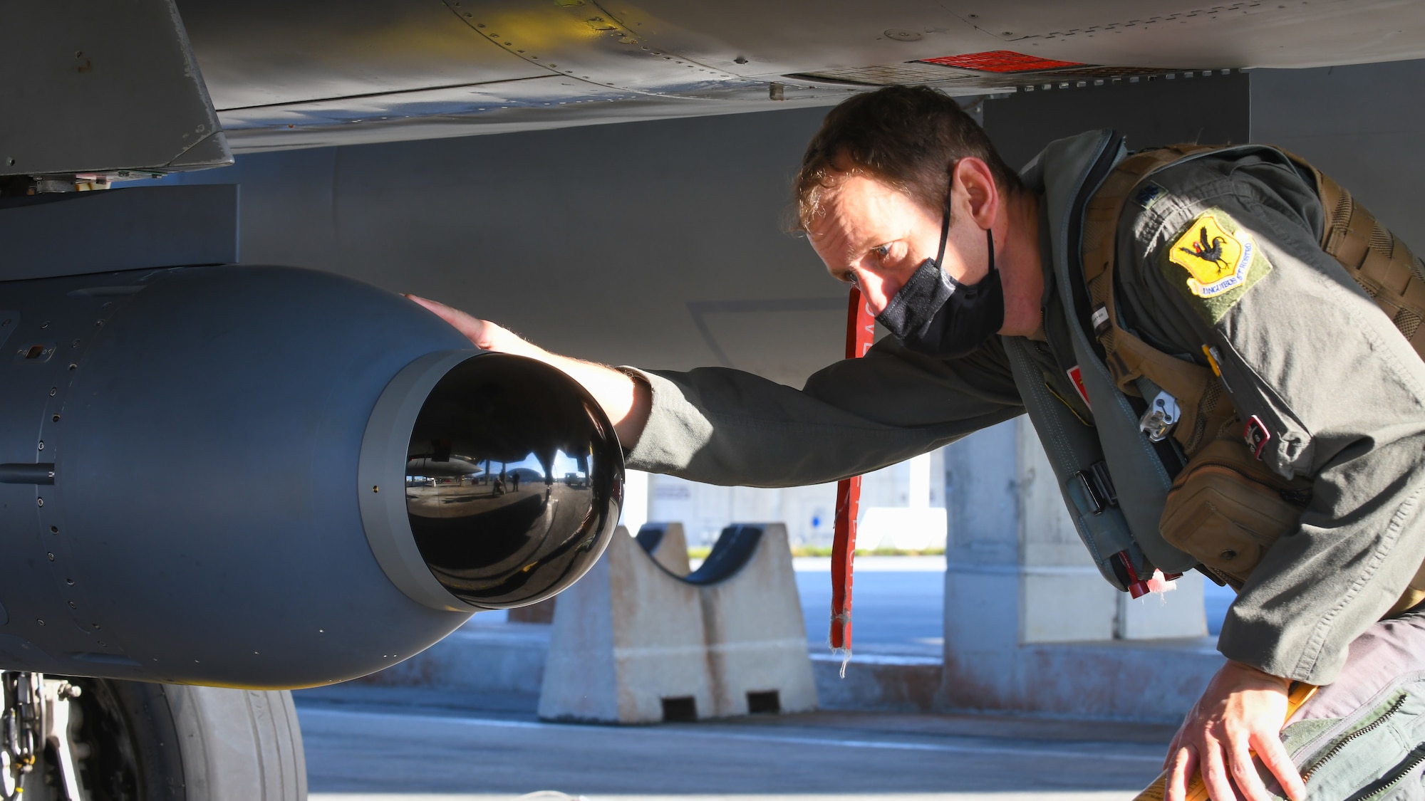 U.S. Air Force pilot inspects a legion pod