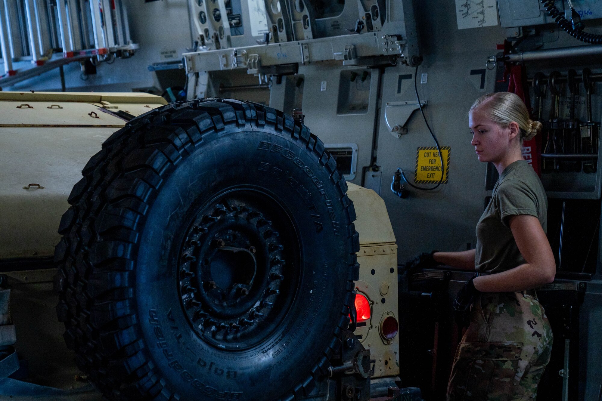 Senior Airman Maya France, 535 Airlift Squadron loadmaster, directs a Humvee onto a C-17 Globemaster III at Joint Base Pearl Harbor-Hickam, Hawaii, Jan. 10, 2022. Loadmasters are responsible for loading and unloading cargo and planning the correct placement of the load to ensure the safety of the passengers and crew. (U.S. Air Force photo by Airman 1st Class Makensie Cooper)