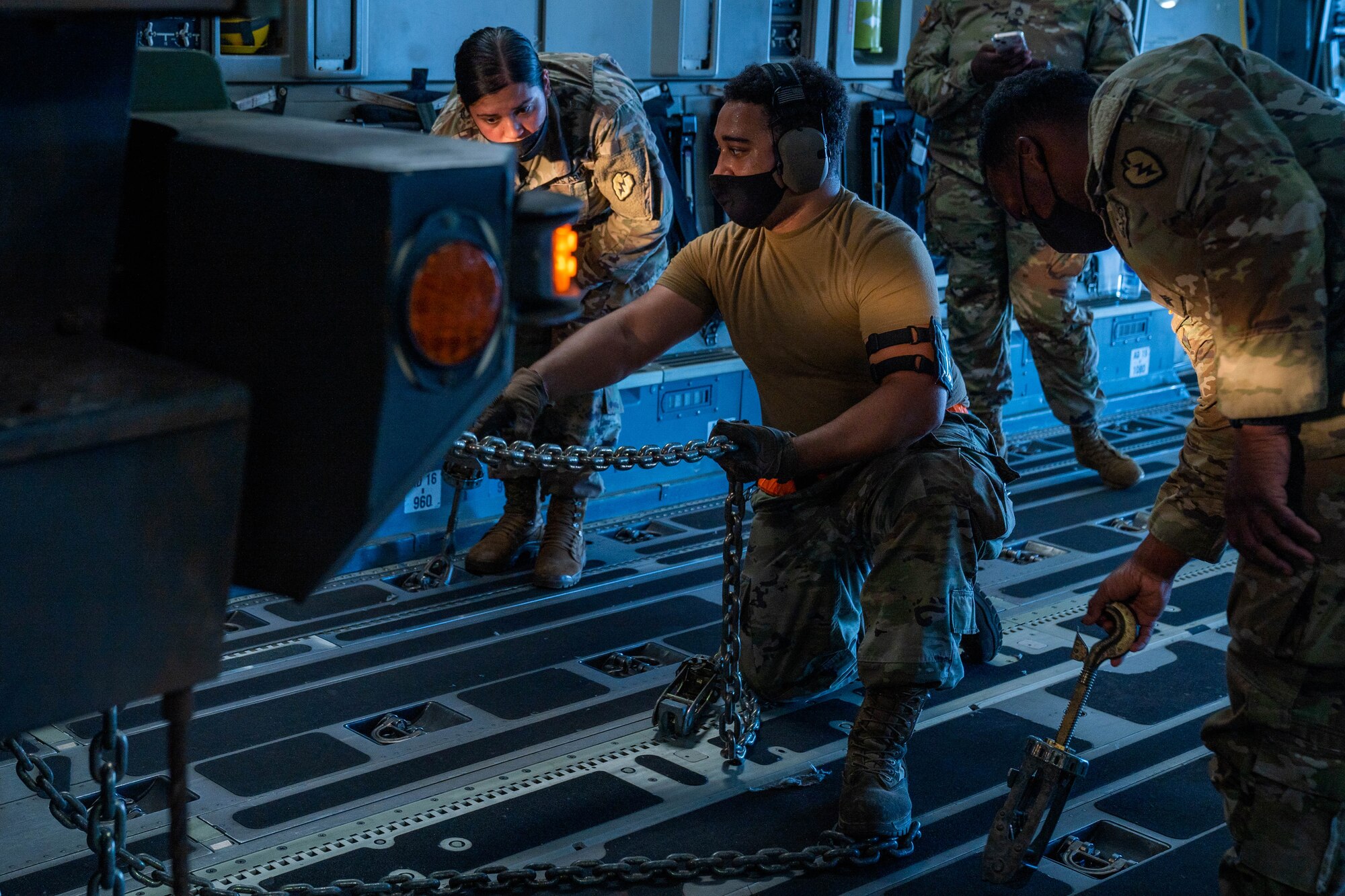 U.S. Air Force Airmen and U.S. Army Soldiers secure a light-medium tactical vehicle on a C-17 Globemaster III during an exercise at Joint Base Pearl Harbor-Hickam, Hawaii, Jan. 10, 2022. Loadmasters are responsible for properly loading and securing cargo and passengers before the flight. (U.S. Air Force photo by Airman 1st Class Makensie Cooper)