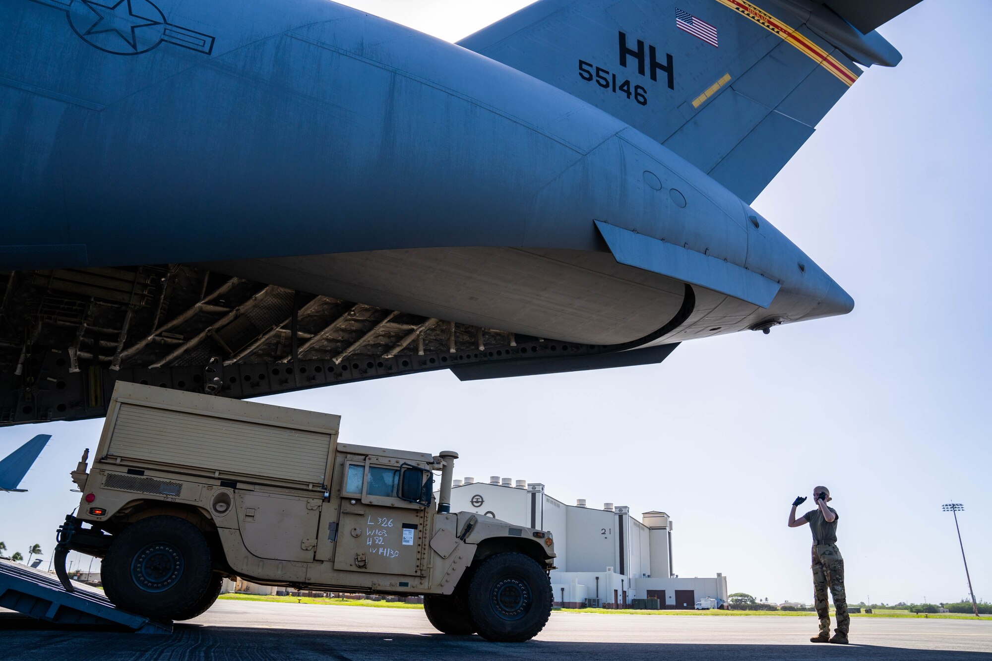 Senior Airman Maya France, 535 Airlift Squadron loadmaster, directs a Joint Light Tactical Vehicle onto a C-17 Globemaster III during an exercise at Joint Base Pearl Harbor-Hickam, Hawaii, Jan. 10, 2022. Loadmasters direct and secure cargo while working hand-in-hand with joint and total force partners to ensure a free and open Indo-Pacific. (U.S. Air Force photo by Airman 1st Class Makensie Cooper)