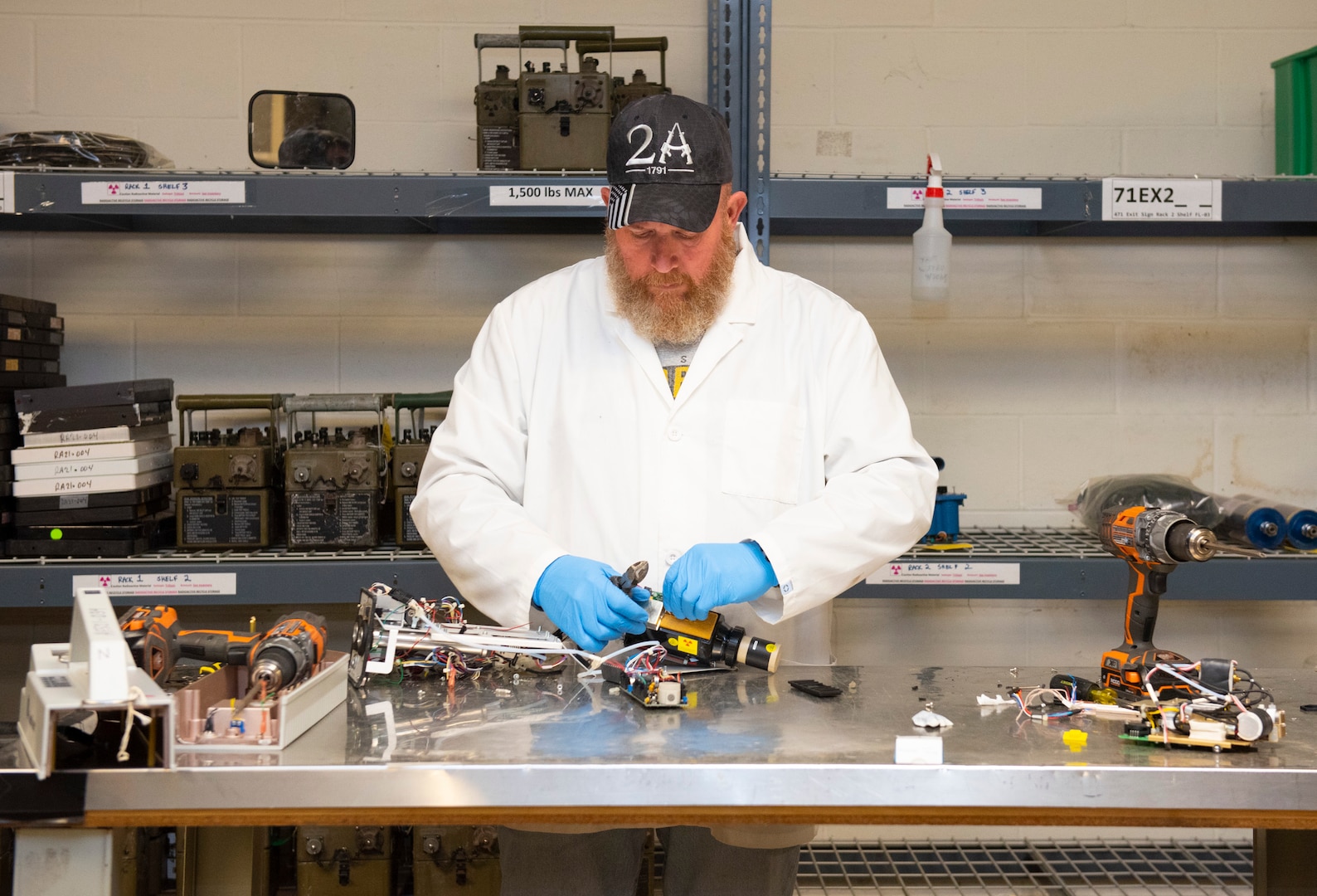 Charlie Mitchell disassembles a piece of equipment to remove the radioactive component at the Air Force Radioactive Recycling and Recycling facility, Dec. 1, 2021 at Wright-Patterson Air Force Base, Ohio. AFRRAD receives thousands of items containing recyclable radioactive material each year. (U.S. Air Force photo by Jaima Fogg)