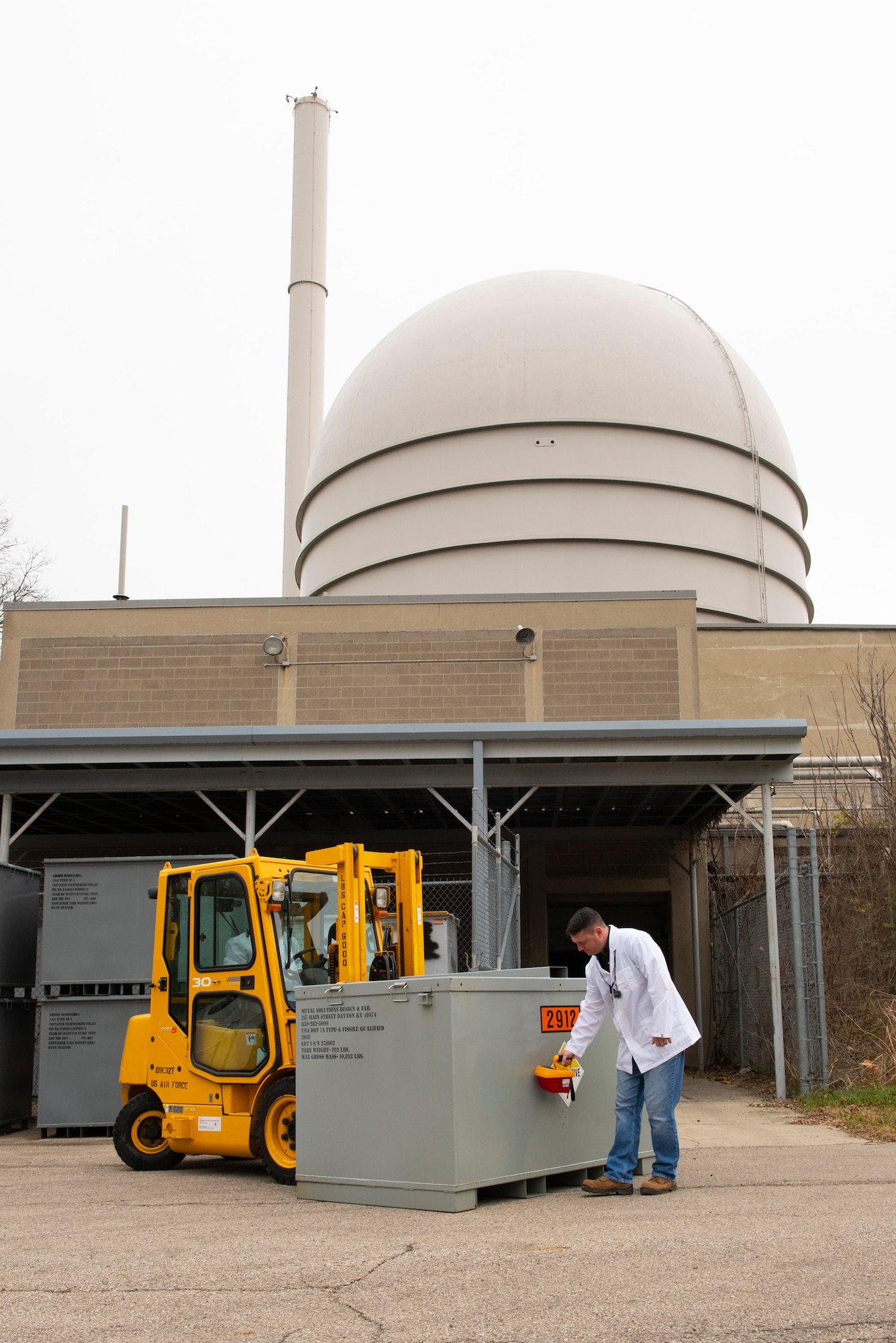 Seth Walton uses a pressurized ionization chamber to assess the radiation dose rate of a container holding radioactive material outside of the Air Force Radioactive Recycling and Disposal facility, Dec. 1, 2021 at Wright-Patterson Air Force Base, Ohio. Radiation dose rate measurements are taken to ensure they fall below the U.S. Department of Transportation’s allowable rate in order to ship low specific activity packages. (U.S. Air Force photo by Jaima Fogg)