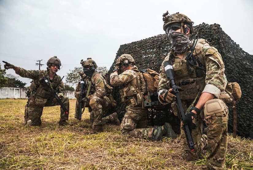 A Brazilian Air Force member, far left, passes on information to  pararescue Airmen from the New York Air National Guard's 106th Rescue Wing  while participating in Execise Tapio 2021, a Brazilian Air Force exercise at Campo Grande Air Base, Campo Grande, Brazil.One hundred and twenty members of the NewYork Air , mostly from the 106th Rescue Wing and 105th Airlift Wing, National Guard participated in the Brazilian Air Force  exercise as part of the National Guard's State Partnership Program from August 19 to 31.  New York has had a partnership with Brazil since 2019. (Brazil Air Force photo by  Anderson Soares)