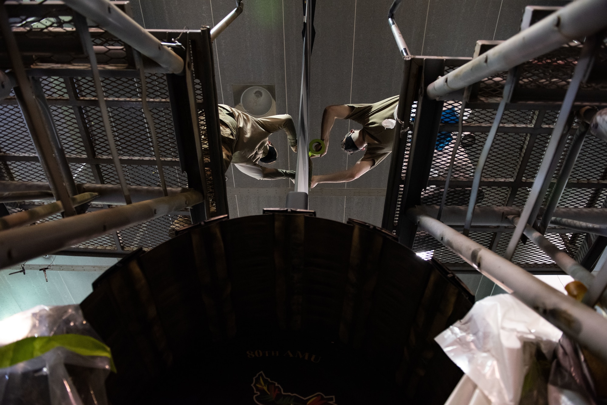 Tech. Sgt. David Lamb, 8th Maintenance Squadron noncommissioned officer in charge of aircraft structural maintenance, right, and Staff Sgt. Alex Dixon, 8th MXS ASM journeyman, left, apply stencils to an F-16 Fighting Falcon