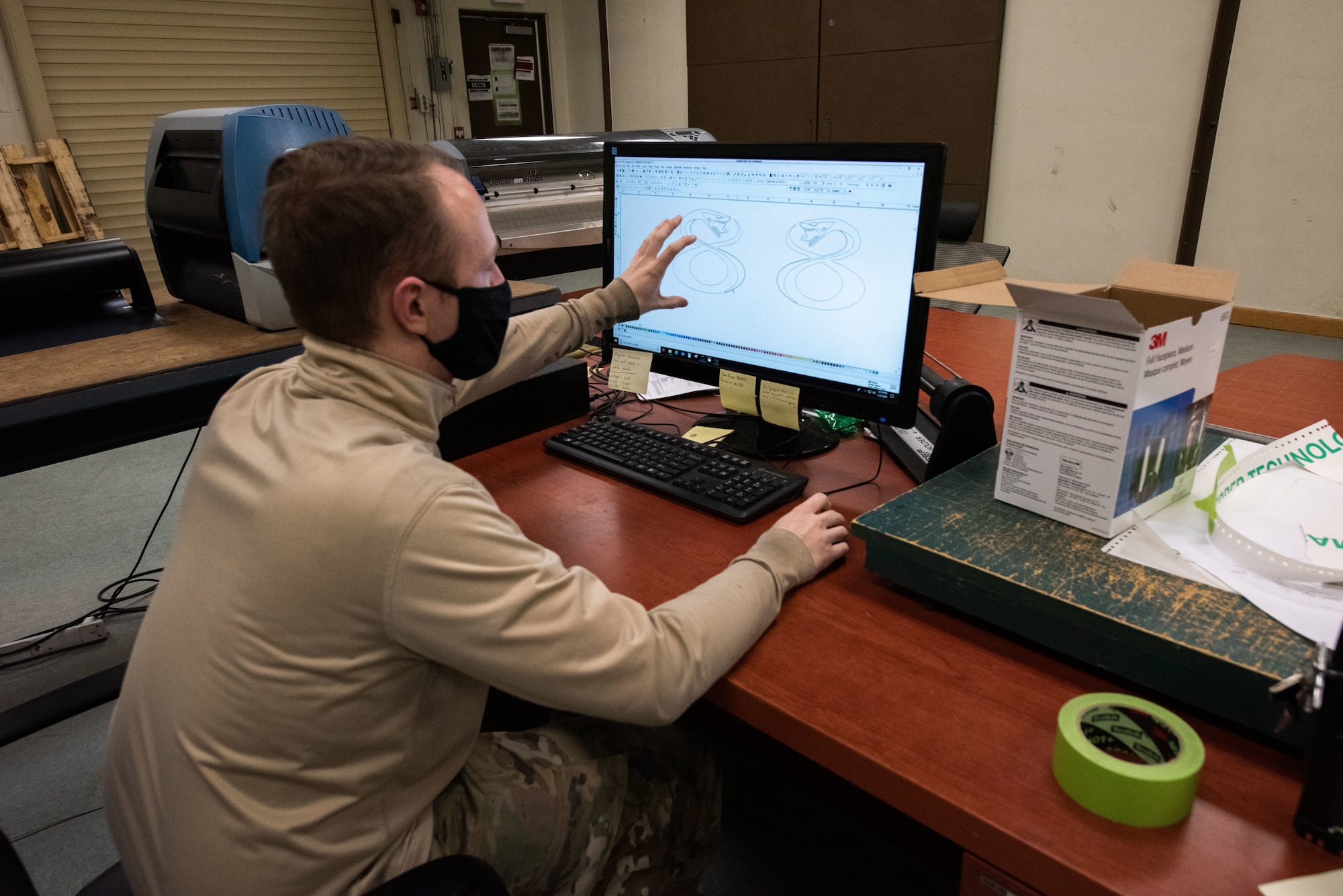 Staff Sgt. Alex Dixon, 8th Maintenance Squadron aircraft structural maintenance journeyman, designs stencils to be used for the 8th Operations Group tail flash