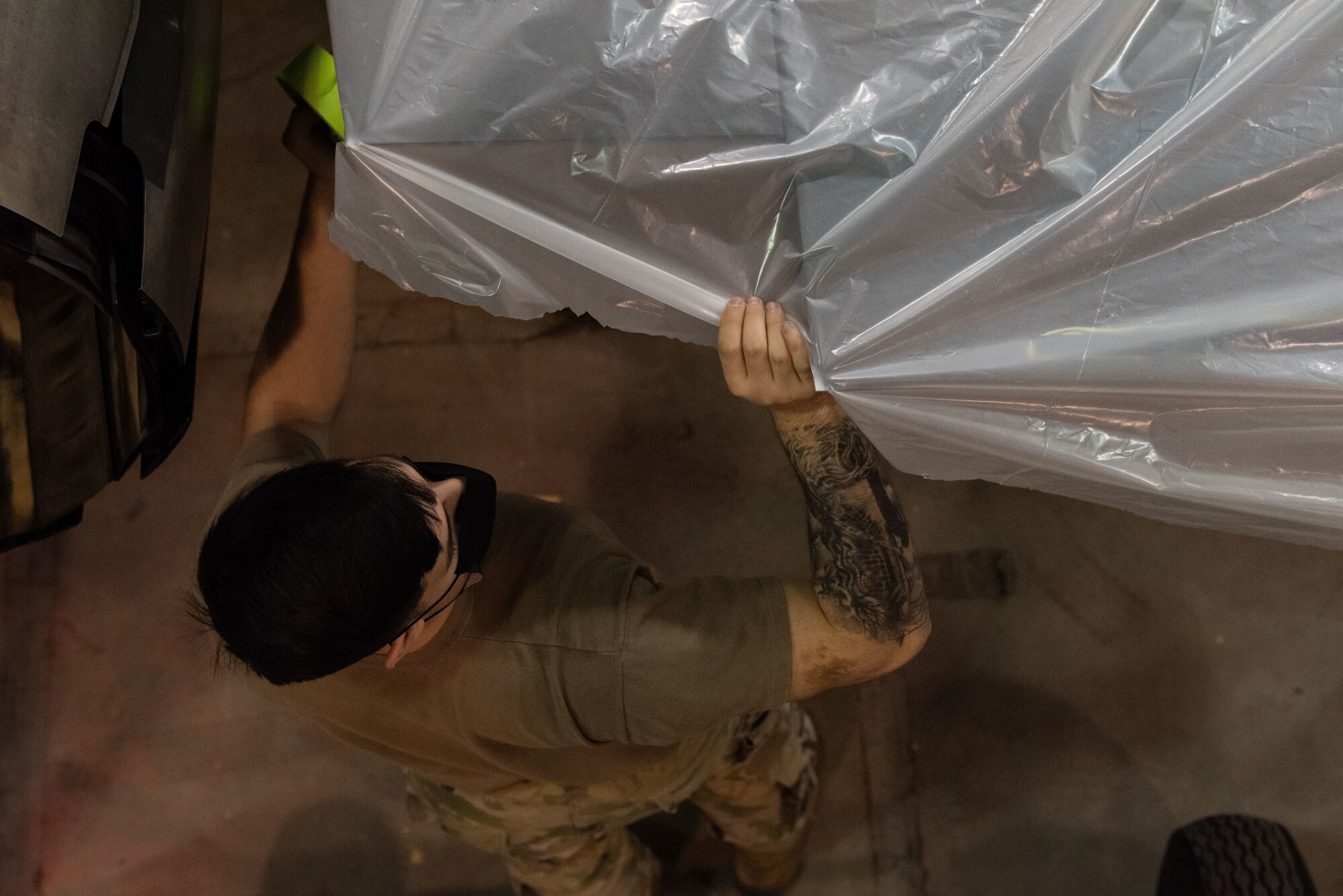 Staff Sgt. Samuel Harris, 8th Maintenance Squadron aircraft structural maintenance craftsman, applies tape and plastic to an F-16 Fighting Falcon in preparation to paint a heritage tail flash