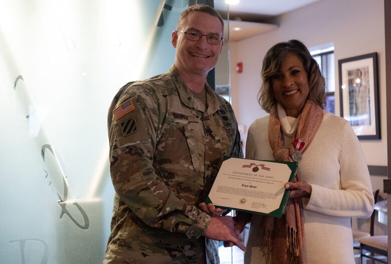 Lucy Soto, Jacksonville District's Equal Employment Opportunity Officer, is wrapping up her more than 36-year career this week while looking forward to her retirement. Soto receives an award from Jacksonville District Commander James Booth during her retirement celebration.