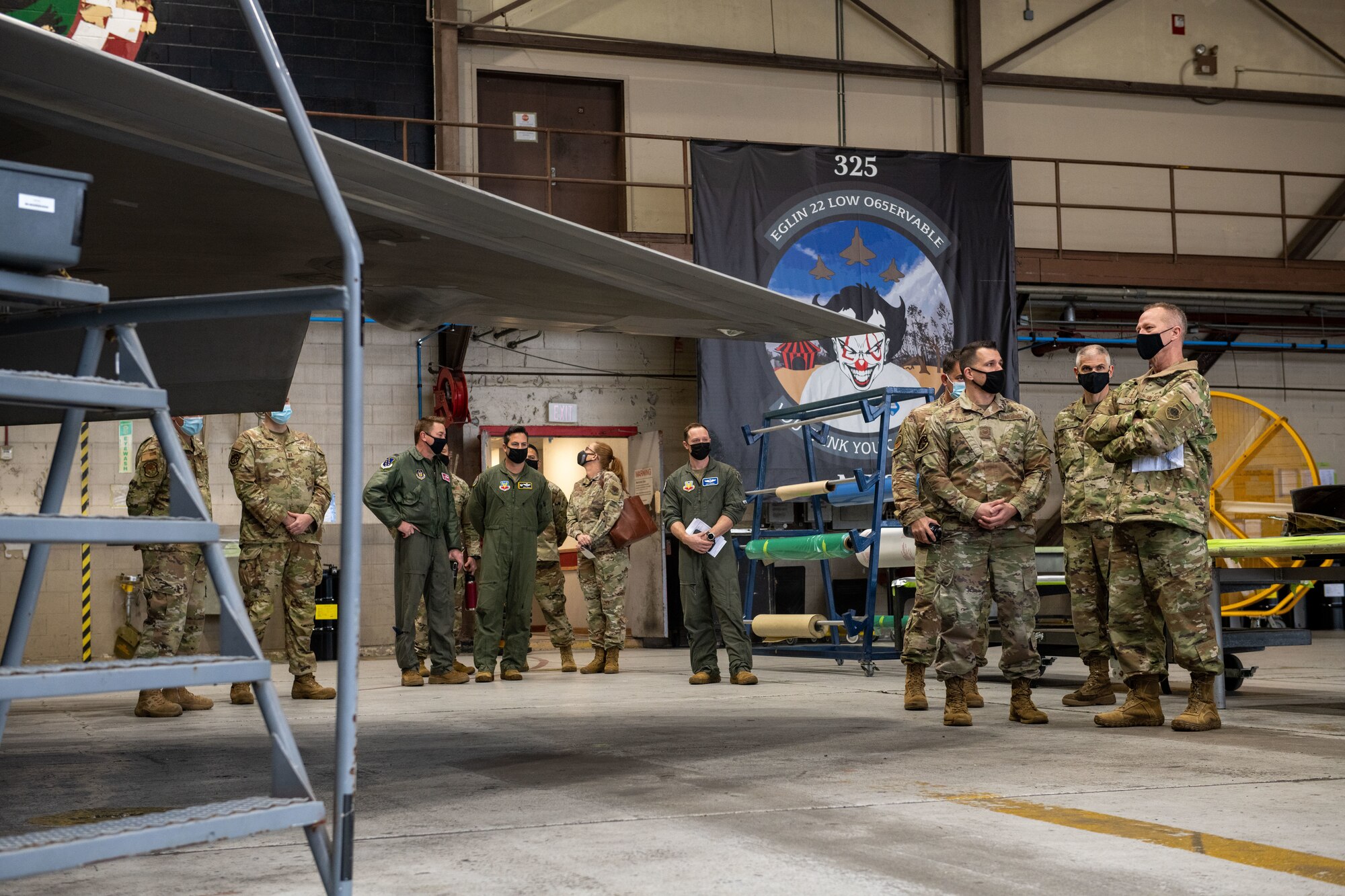 airmen talk in a hangar