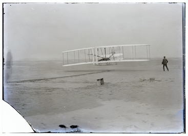 Iconic photo of the first heavier-than-air flight. Image taken take by USLSS John T. Daniels 12/17/1903.
