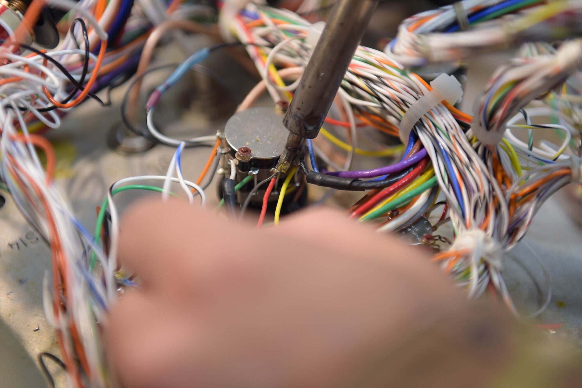 A photo of hand and wires.