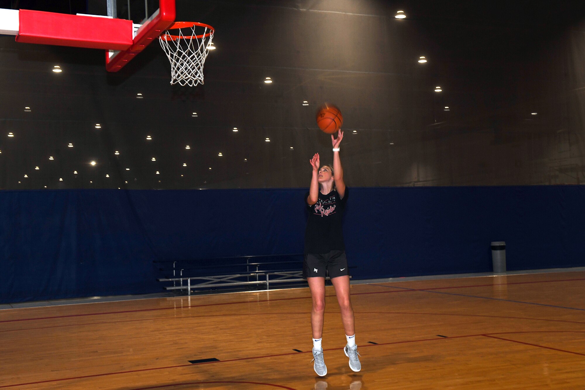 Woman shoots a basketball