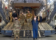 Team Charleston Airmen escort attendees of Clergy Day down the ramp of a C-17 Globemaster III static display at Joint Base Charleston, S.C., Jan 25, 2022.