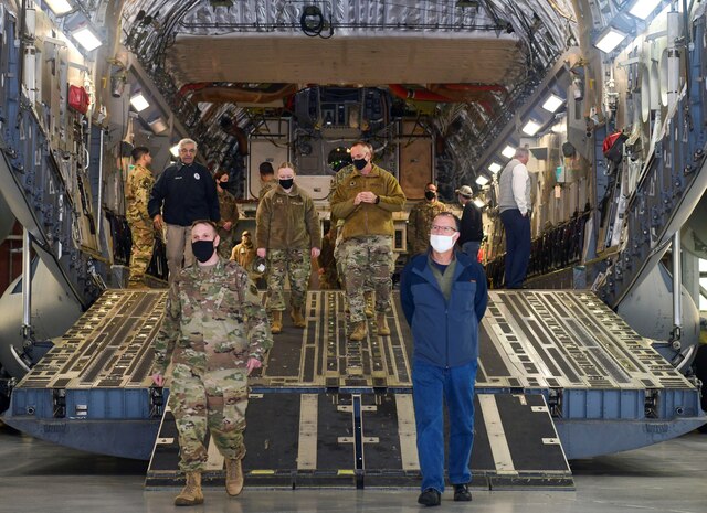 Team Charleston Airmen escort attendees of Clergy Day down the ramp of a C-17 Globemaster III static display at Joint Base Charleston, S.C., Jan 25, 2022.