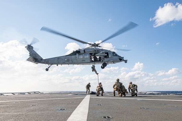 Explosive Ordnance Disposal Mobile Unit (EODMU) 2 assigned to Carrier Strike Group 8 and an MH-60S Sea Hawk helicopter assigned to the "Dragon Slayers" of Helicopter Sea Combat Squadron (HSC) 11, conducts a fast roping evolution with the Norwegian Royal Navy Fridtjof Nansen-class frigate HNoMS Fridtjof Nansen (F310) during Neptune Strike 2022,