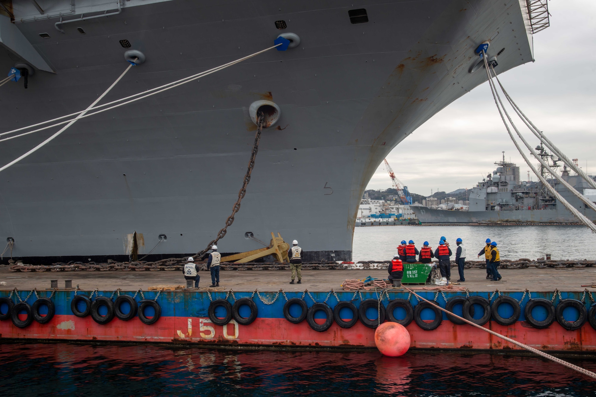 Sailors stand by to perform maintenance on the starboard anchor chain aboard the U.S. Navy’s only forward-deployed aircraft carrier USS Ronald Reagan (CVN 76).