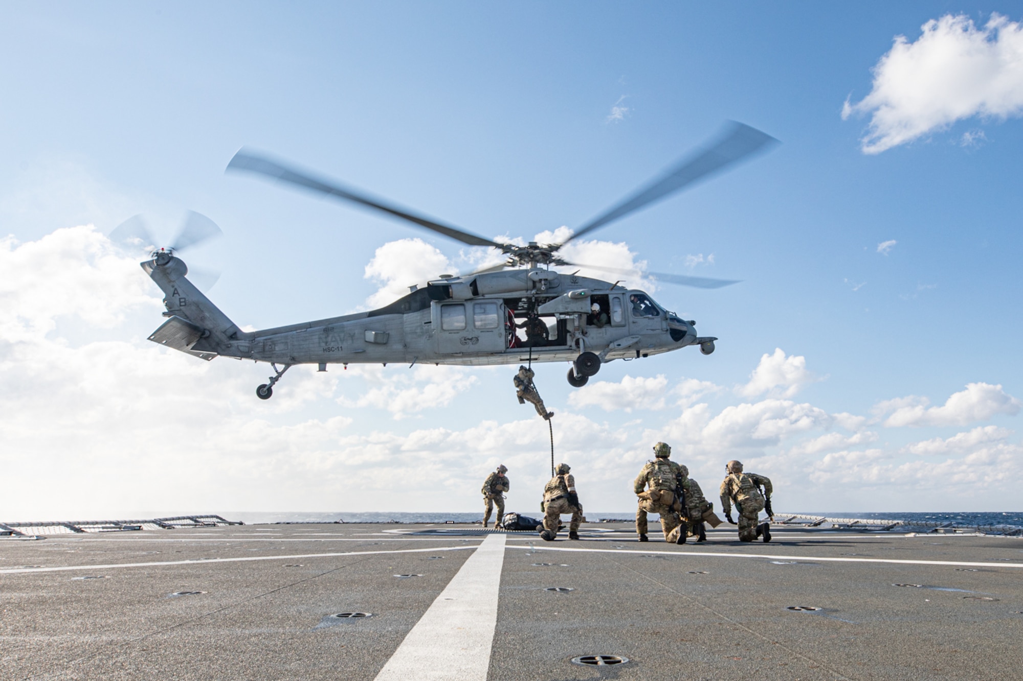 Explosive Ordnance Disposal Mobile Unit (EODMU) 2 assigned to Carrier Strike Group 8 and an MH-60S Sea Hawk helicopter assigned to the "Dragon Slayers" of Helicopter Sea Combat Squadron (HSC) 11, conducts a fast roping evolution with the Norwegian Royal Navy Fridtjof Nansen-class frigate HNoMS Fridtjof Nansen (F310) during Neptune Strike 2022,