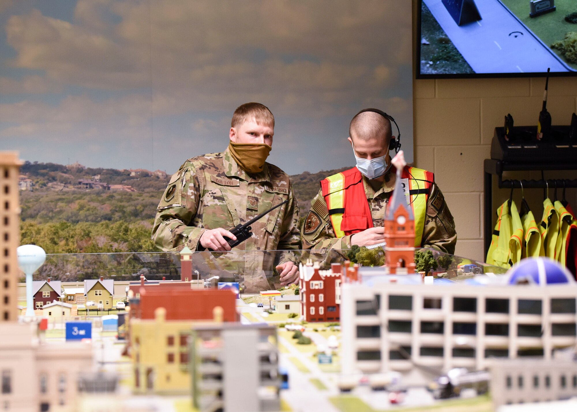 U.S. Air Force Tech. Sgt. Kenneth Colton, 312th Training Squadron fire officer training section chief, instructs a student during a fire response simulation at the Louis F. Garland Department of Defense Fire Academy