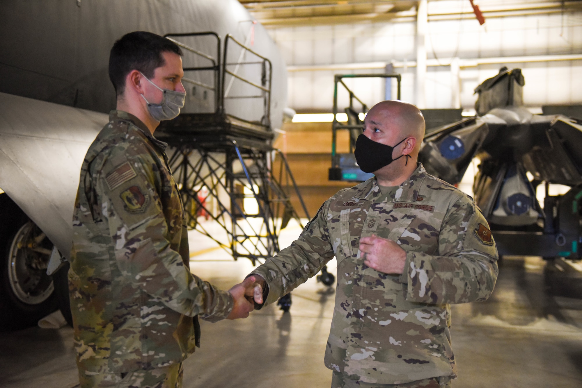 Chief Master Sgt. Cenov shakes hands with an Airman