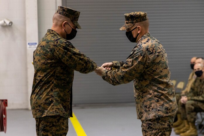 U.S. Marine Corps Sgt. Maj. Marcos R. Gonzalezceja, incoming sergeant major, 2nd Transportation Battalion, receives the non-commissioned officer sword from Lt. Col. Randall D. White, commanding officer of 2nd Transportation Battalion, during a relief and appointment ceremony on Camp Lejeune, North Carolina, Jan. 28, 2022. The passing of the sword represents the transition of authority from one Sgt. Maj. to another. During the ceremony, Sgt. Maj. Ariton transferred the position to Sgt. Maj. Gonzalezceja who was appointed as the new 2nd Transportation Battalion Sergeant Major. (U.S. Marine Corps photo taken by Lance Cpl. Jessica J. Mazzamuto)