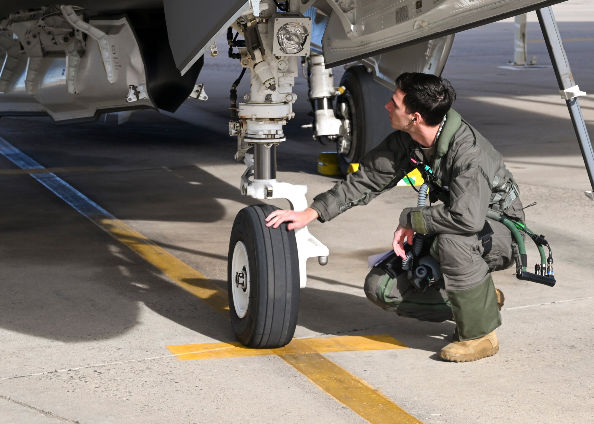 U.S. Air Force 1st Lt. Nicholas “Trek” Gossner, 308th Fighter Squadron F-35A Lightning II student pilot, inspects his aircraft before a flight Jan. 12, 2022, at Luke Air Force Base, Ariz.