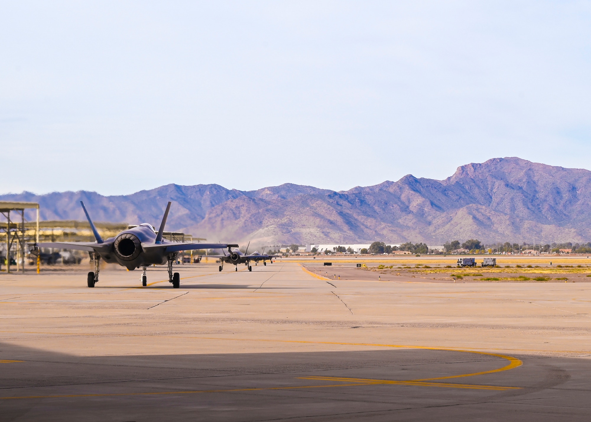 U.S. Air Force Capt. Sean “Echo” Gossner, 63rd Fighter Squadron F-35A Lightning II instructor pilot, and his brother 1st Lt. Nicholas “Trek” Gossner, 308th FS F-35A student pilot, taxi in their F-35A aircraft down the flight line Jan. 12, 2022, at Luke Air Force Base, Ariz.