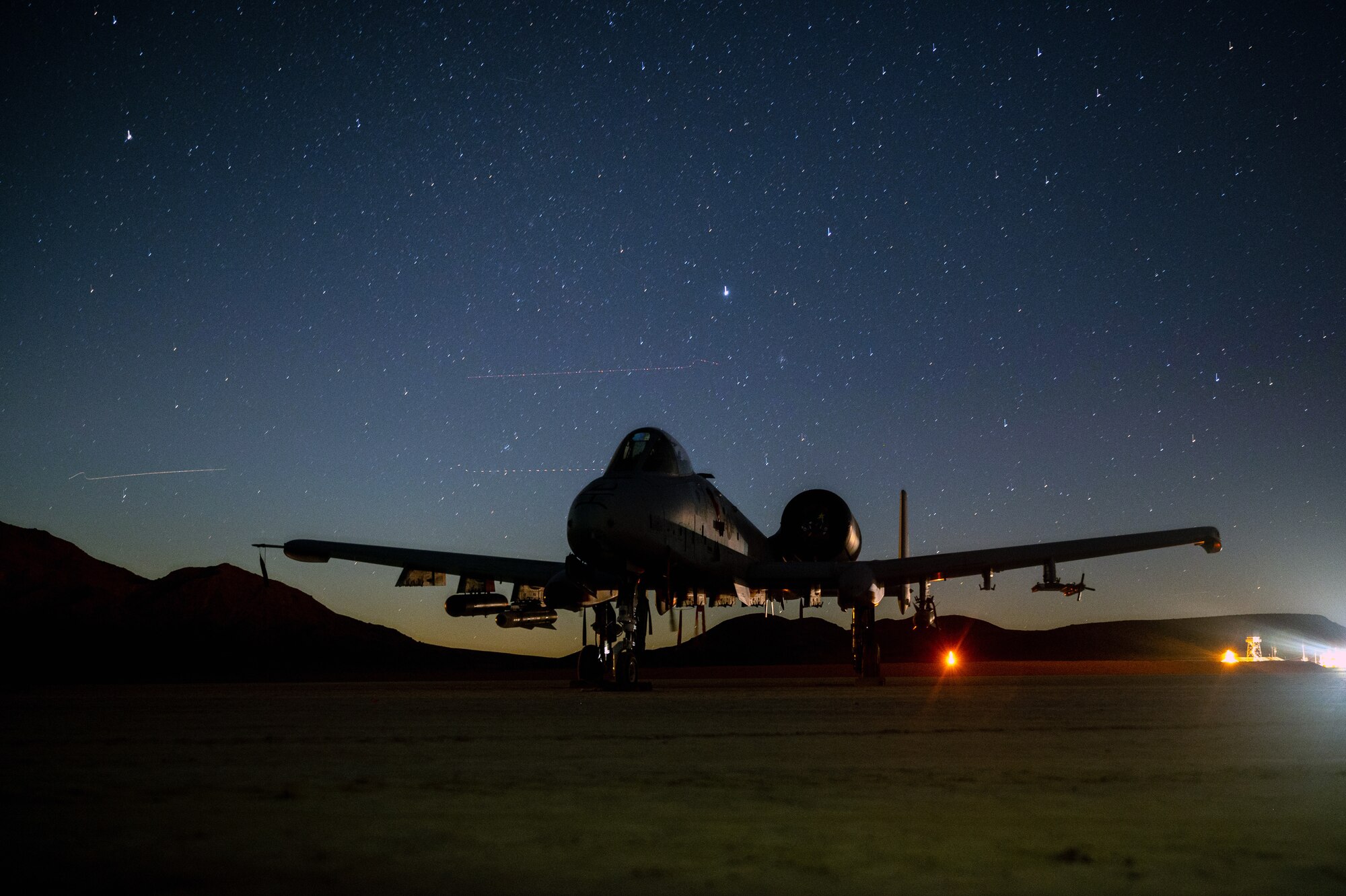 An A-10 Thunderbolt II assigned to Davis-Monthan Air Force Base, Ariz., parks in a dry lakebed