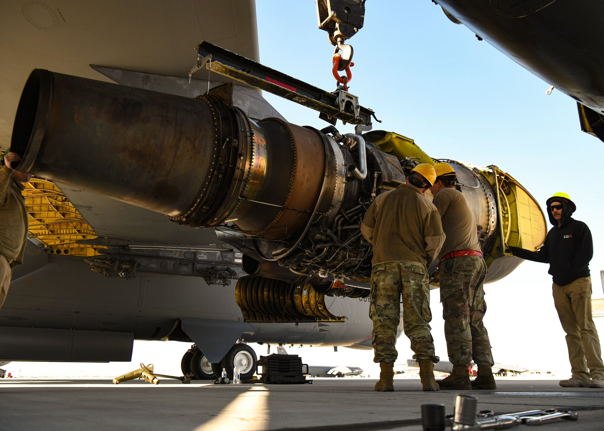 Airmen replace an engine on a B-52
