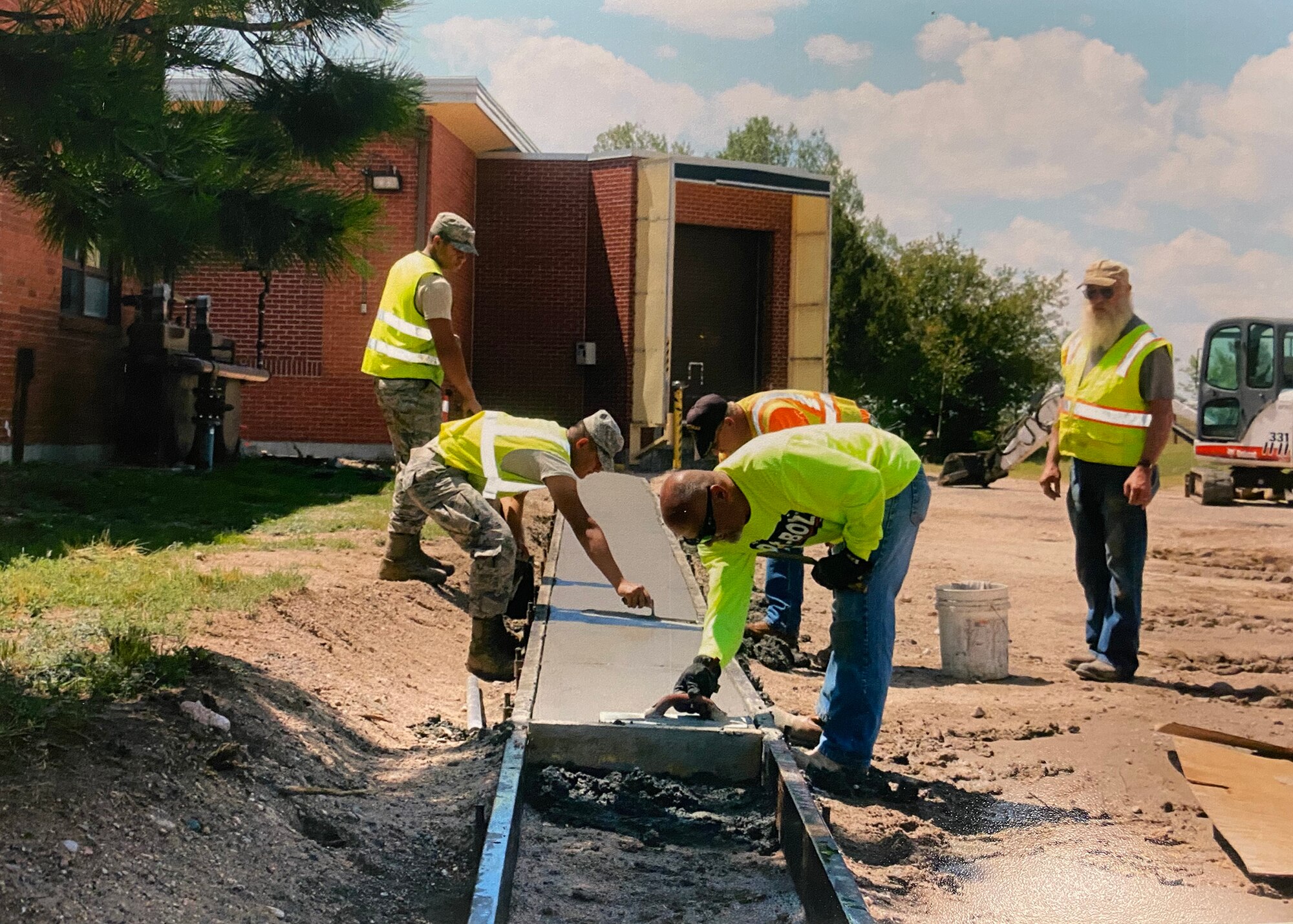 Dirt Boyz work on laying concrete.