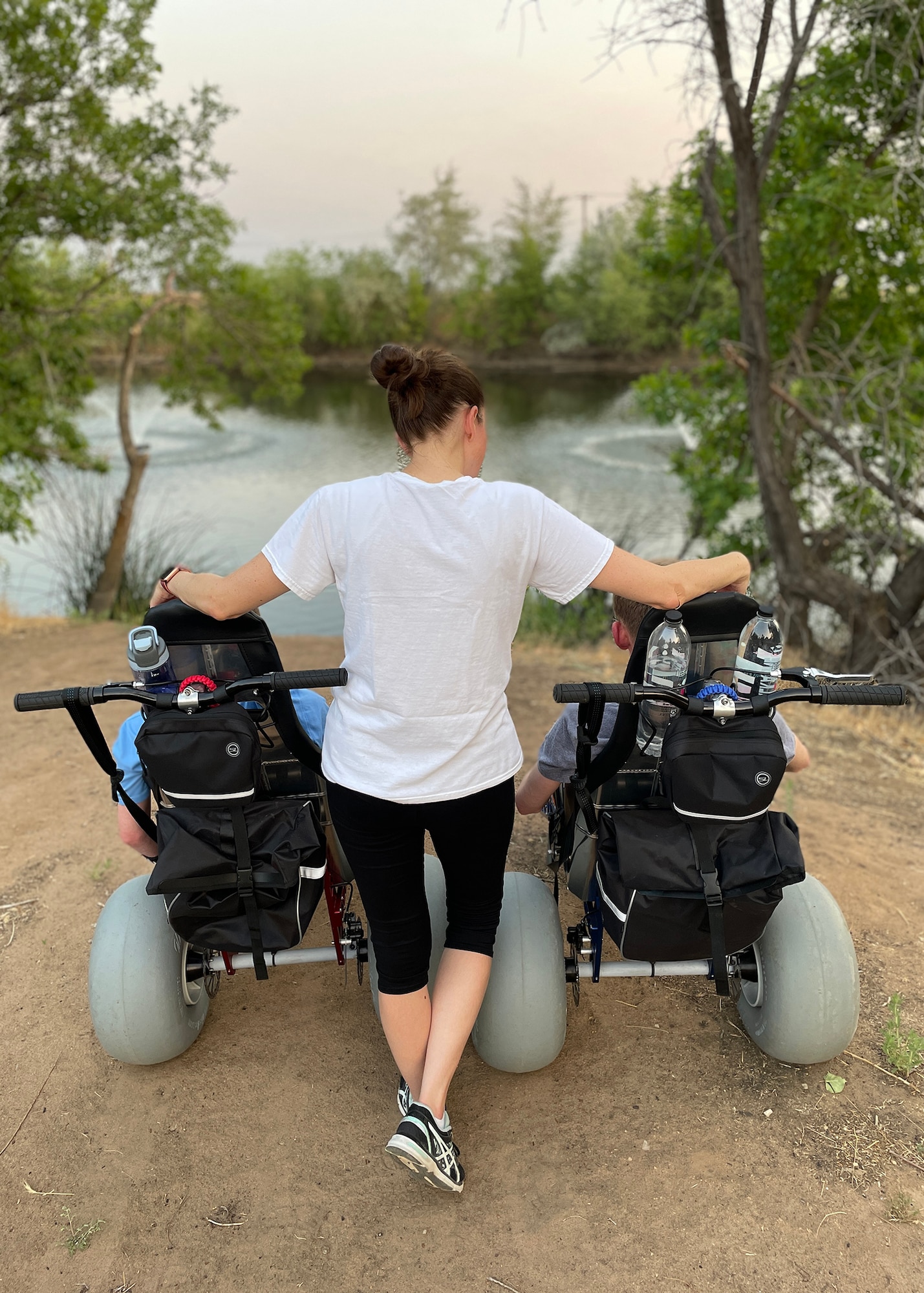 Laura Graham, wife of Master Sgt. Jared Graham, 75th Logistics Readiness Squadron, gazes at a lake with sons Dino and Tyson, while hiking in their new all-terrain wheelchairs. The Grahams’ received a special needs grant offered by the Air Force Aid Society to purchase the “adventurous wheels” for their sons, enabling them to enjoy the outdoors more. (Courtesy photo)
