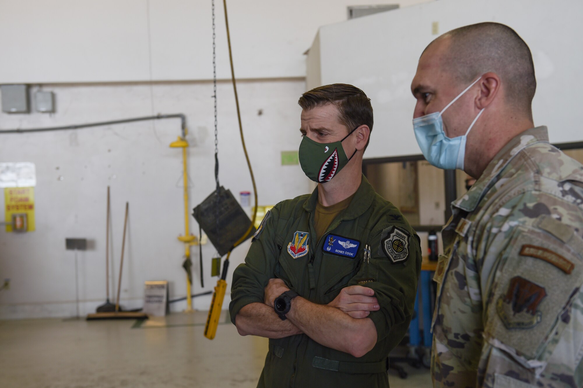 U.S. Air Force Col. Russ Cook, 23rd Wing commander, and Master Sgt. Nick Russell, 41st Rescue Generation Squadron phase inspection section chief, observe a phase inspection of the HH-60W Jolly Green II helicopter at Moody Air Force Base, Georgia, Jan. 20, 2022. This is the first phase inspection of a Whiskey and will set the standard for how inspections are done moving forward. (U.S. Air Force photo by Airman 1st Class Briana Beavers)
