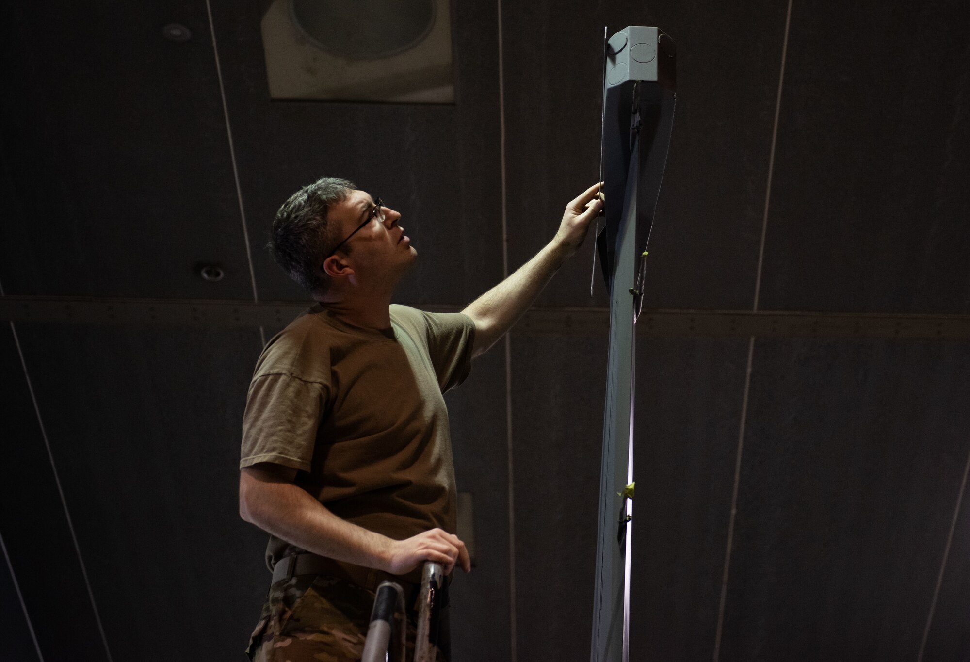 Tech. Sgt. David Lamb, 8th Maintenance Squadron noncommissioned officer in charge of aircraft structural maintenance, measures the top of an F-16 Fighting Falcon tail fin prior to adding stencils for the painting of the 8th Fighter Wing’s fourth and final heritage tail flash