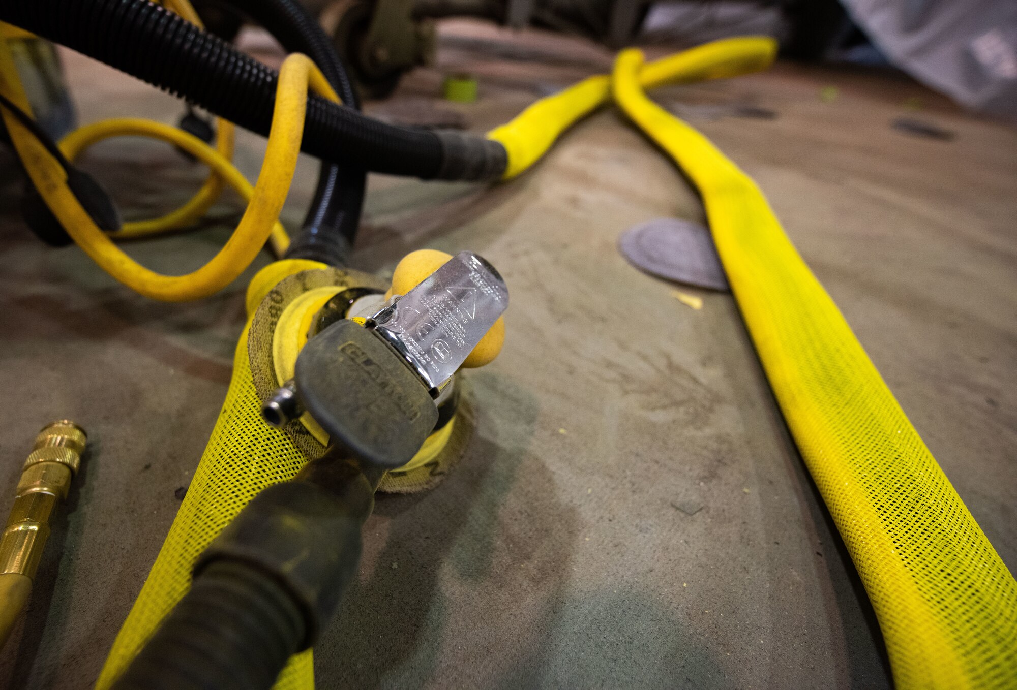 Grinder handle and power cables lie unused in the 8th Maintenance Squadron aircraft structural maintenance shop