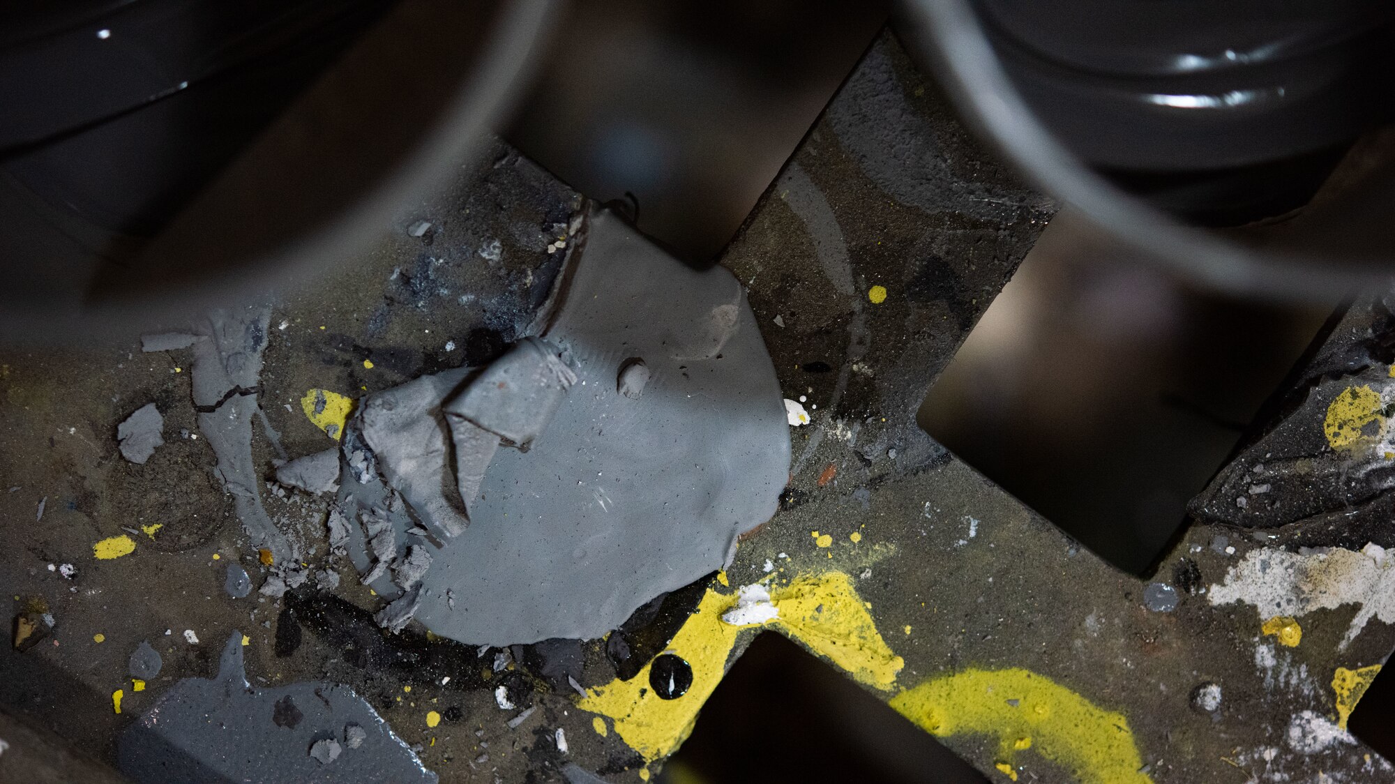Remnants of paint lie on the ground of the 8th Maintenance Squadron aircraft structural maintenance shop
