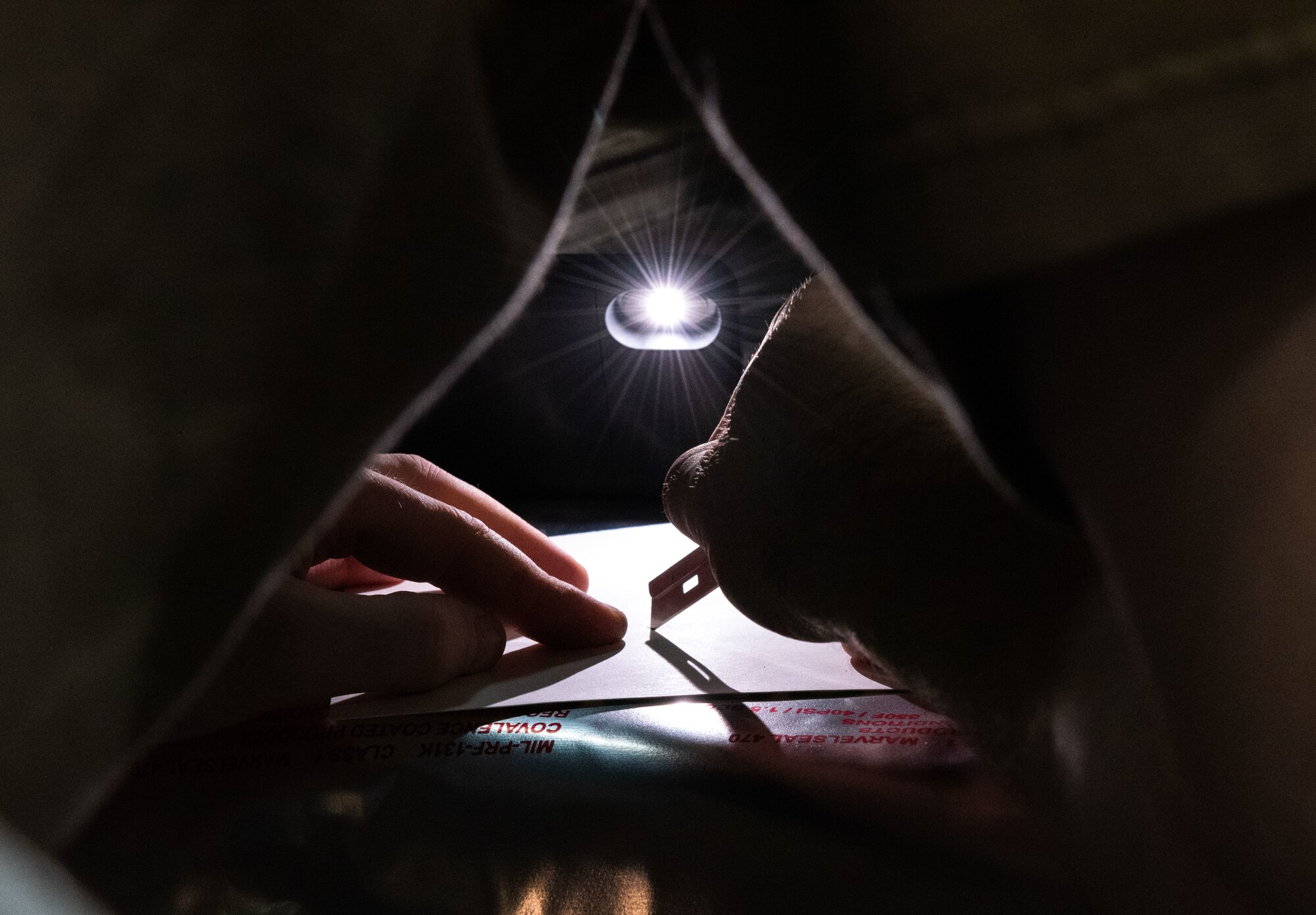 Tech. Sgt. David Lamb, 8th Maintenance Squadron noncommissioned officer in charge of aircraft structural maintenance, cuts out a stencil to be applied to an F-16 Fighting Falcon for the painting of the 8th Fighter Wing’s fourth and final heritage tail flash