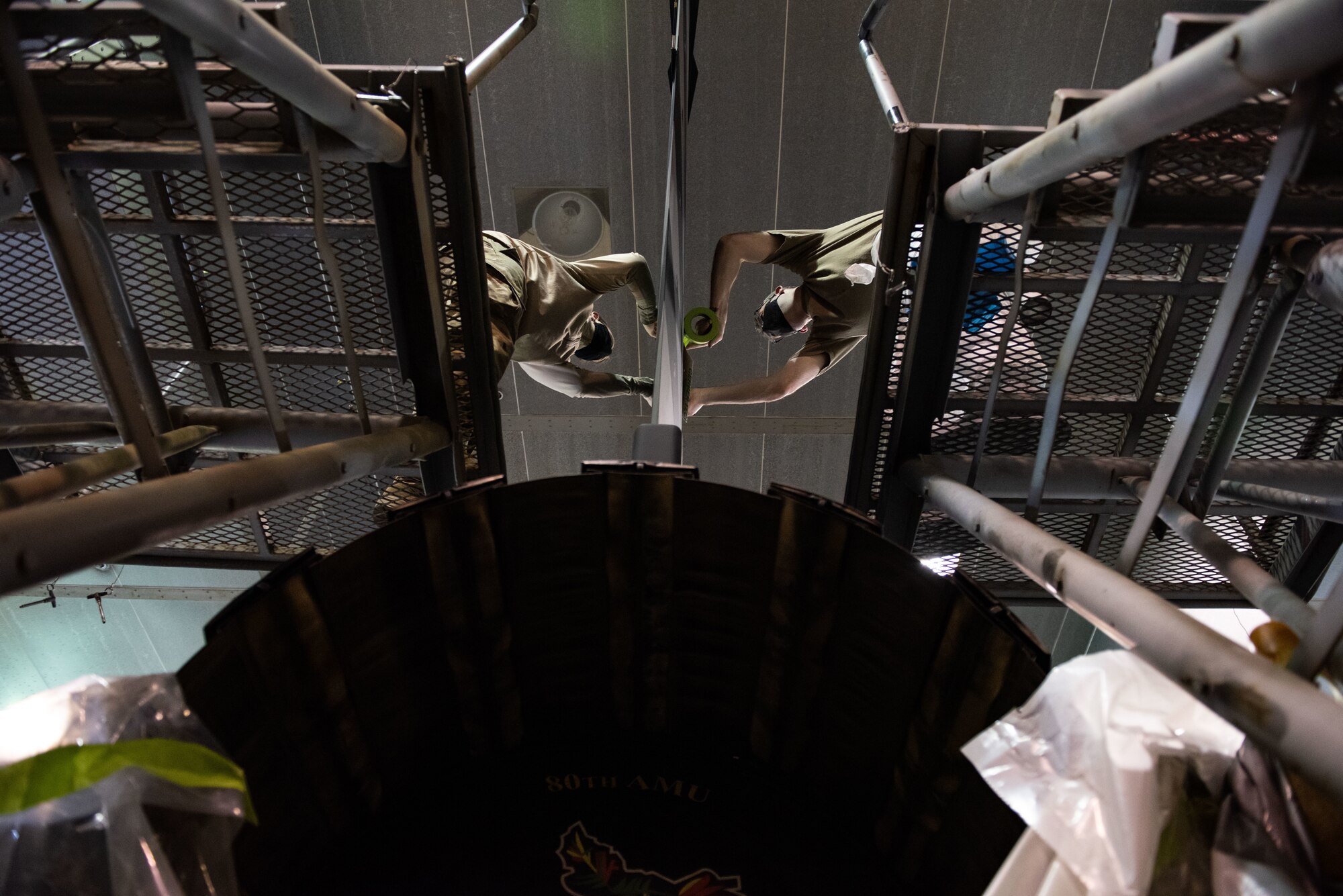 Tech. Sgt. David Lamb, 8th Maintenance Squadron noncommissioned officer in charge of aircraft structural maintenance, right, and Staff Sgt. Alex Dixon, 8th MXS ASM journeyman, left, apply stencils to an F-16 Fighting Falcon