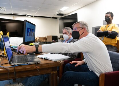 Dr. David Mayo, right, a mechanical engineer with the Naval Air Warfare Center Aircraft Division; Dr. Tom Jenkins, center, president of MetroLaser, Inc.; and Regis Morgan, senior engineer with MetroLaser, monitor data during a test.
