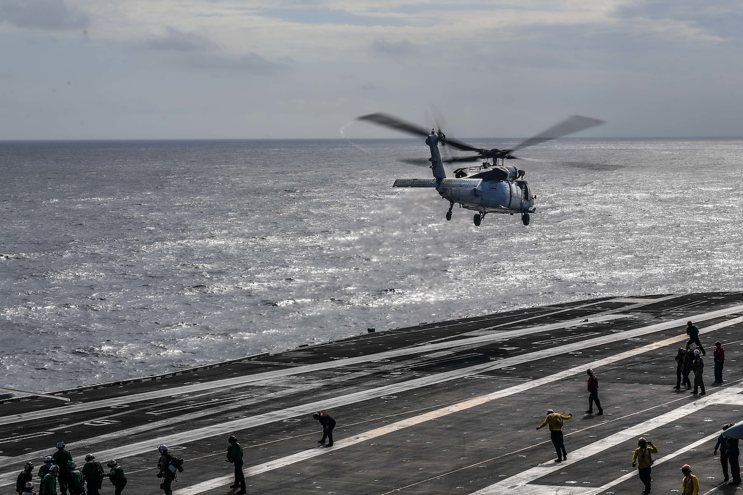 An MH-60S Sea Hawk, assigned to the “Black Knights” of Helicopter Maritime Strike Squadron (HSC) 4, lifts off the flight deck of the Nimitz-class aircraft carrier USS Carl Vinson (CVN 70).