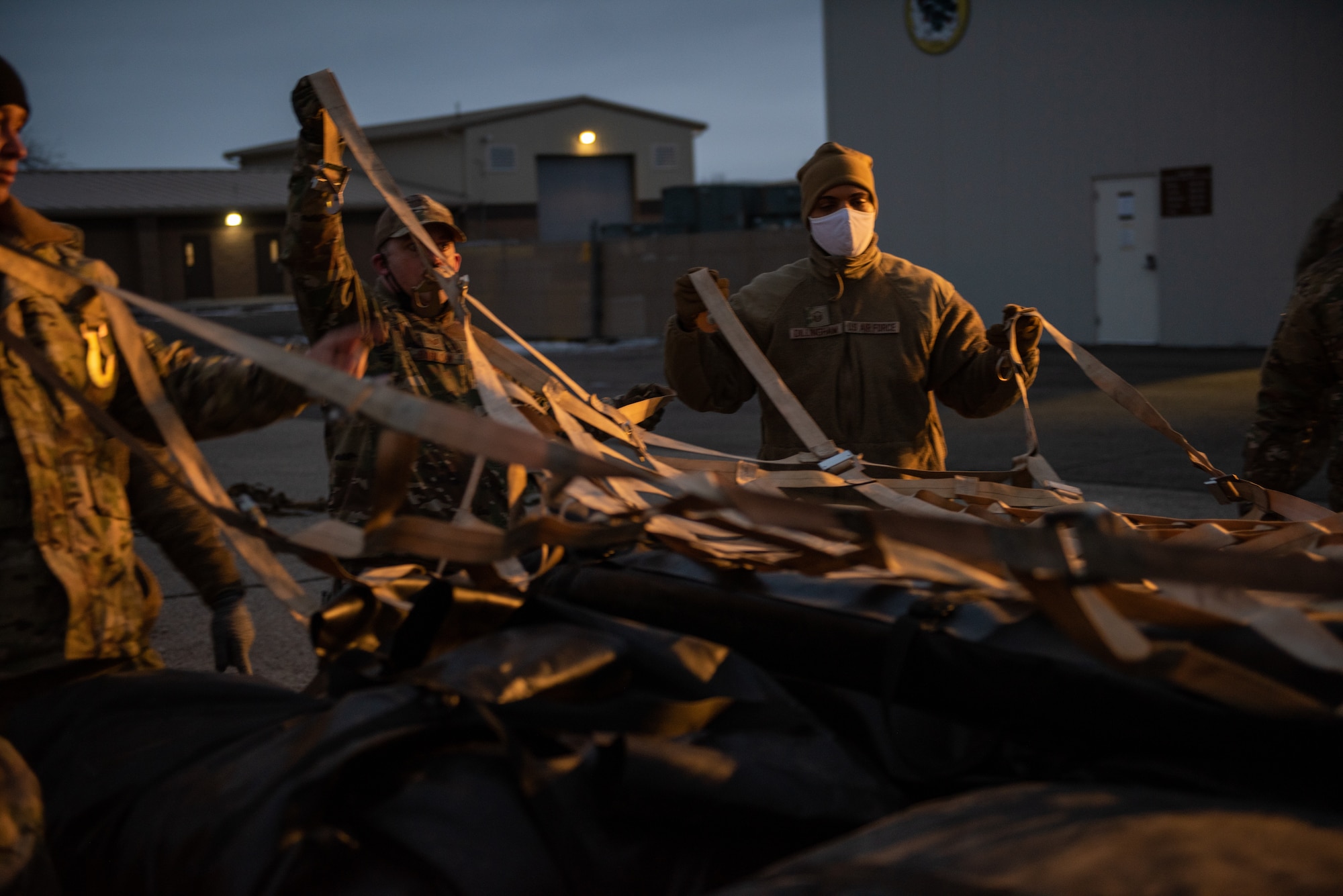 Airmen working to together to prepare cargo.