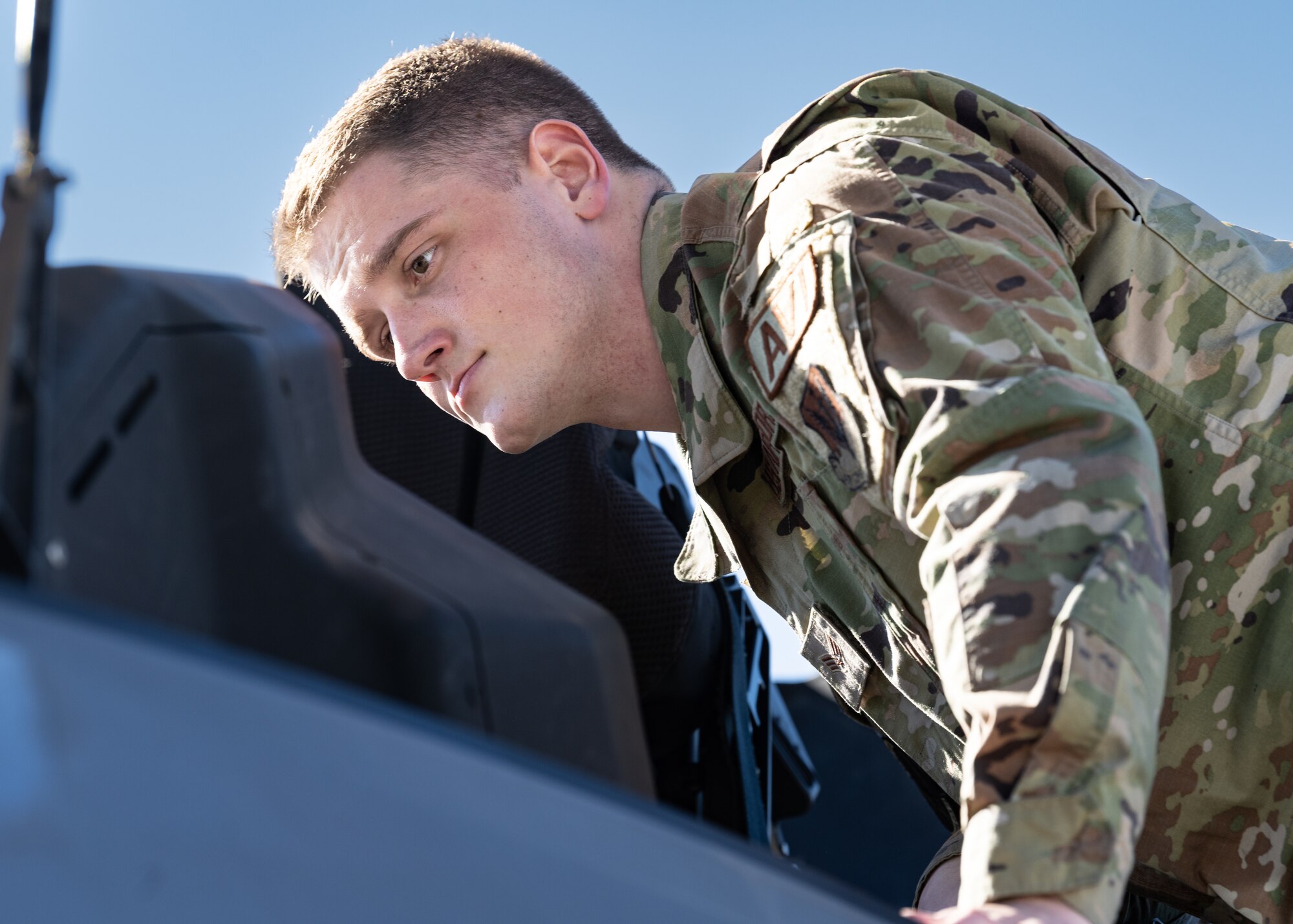 A photo of an Airman inspecting a jet