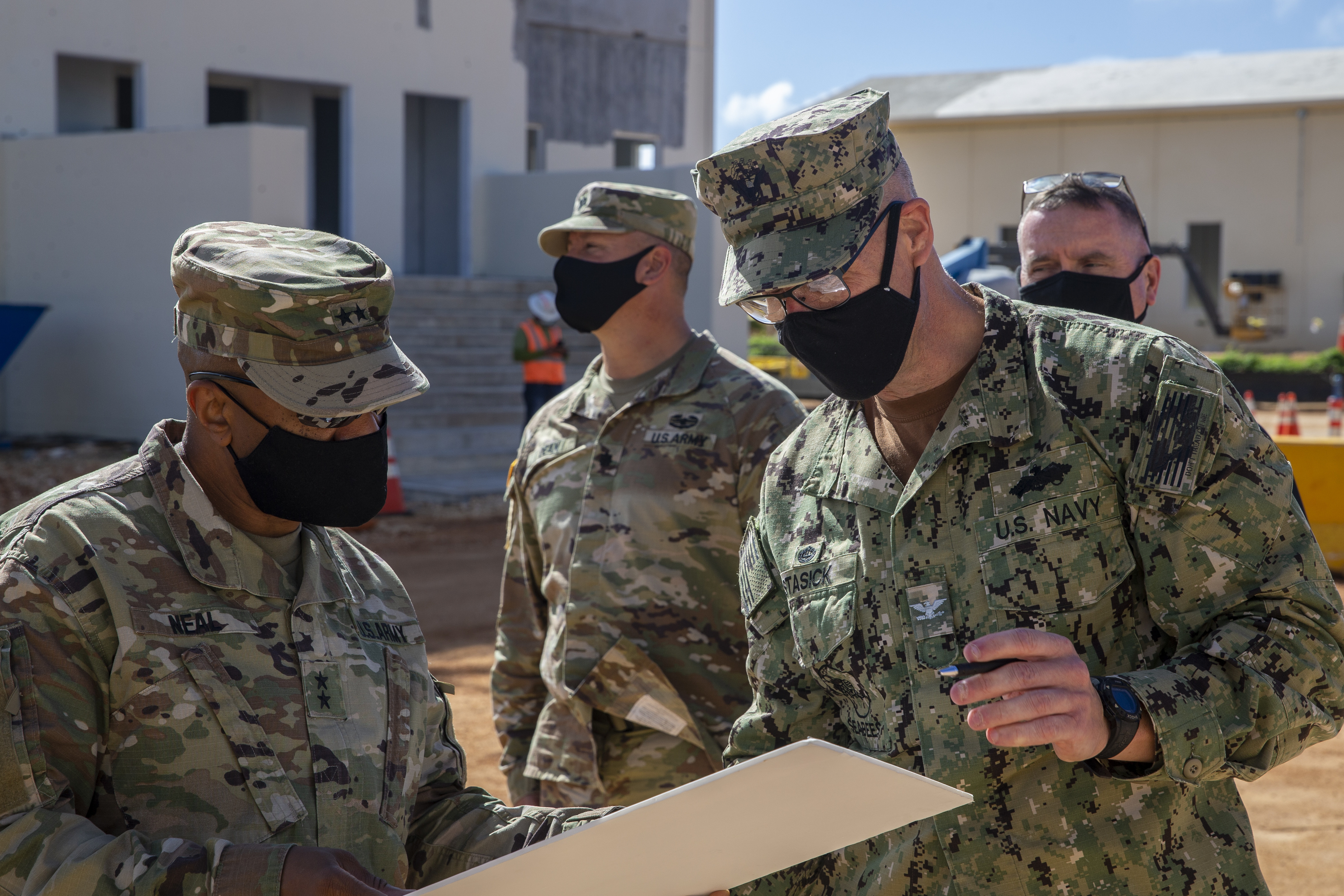 U.S. Navy Capt. Steven Stasick, the Officer In Charge of Construction Marianas commanding officer, right, briefs U.S. Army Maj. Gen. Reginald Neal, the U.S. Army Pacific deputy commanding general Army National Guard, during a visit to the Marine Corps Base (MCB) Camp Blaz military operations on urban terrain (MOUT) construction site, Jan. 26, 2022.