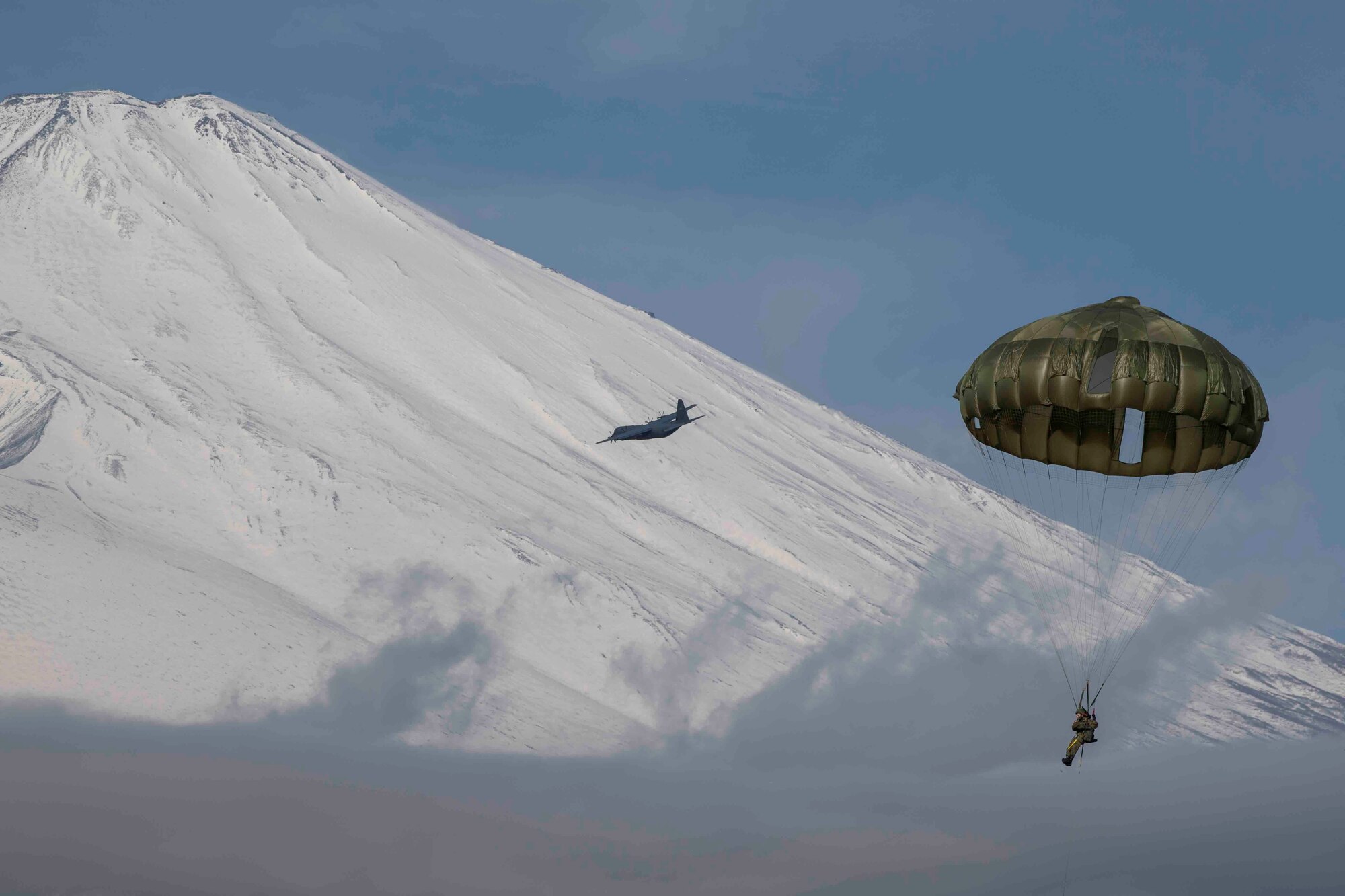 A Japan Ground Self-Defense Force paratrooper assigned to the 1st Airborne Brigade descends from a U.S. Air Force C-130J Super Hercules assigned to the 36th Airlift Squadron over Combined Arms Training Center Camp Fuji, Japan, during Airborne 22, Jan. 25, 2022.