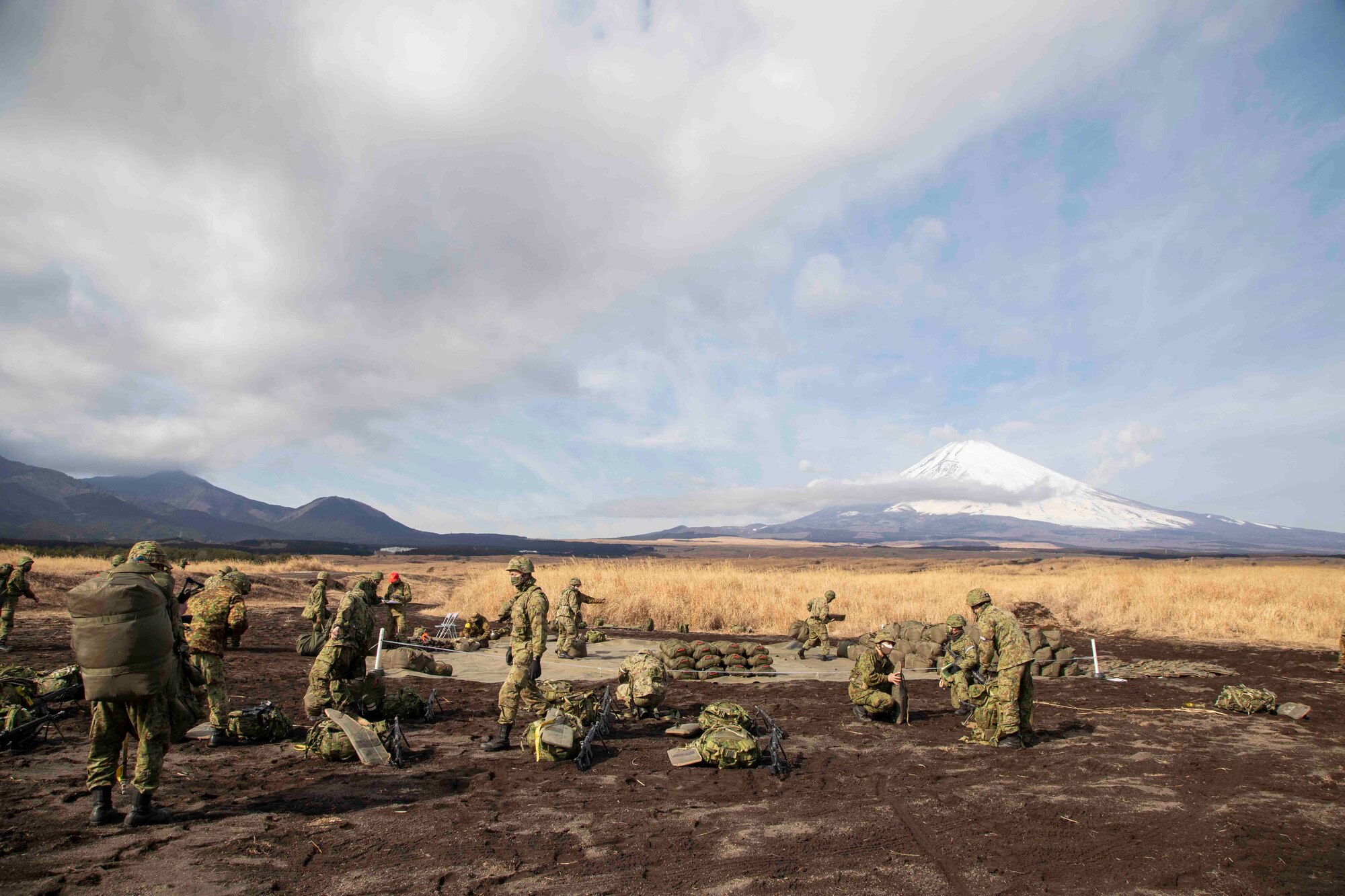 Japan Ground Self-Defense Force paratroopers assigned to the 1st Airborne Brigade gather after landing at the drop zone at Combined Arms Training Center Camp Fuji, Japan, Jan. 25, 2022, during Airborne 22.