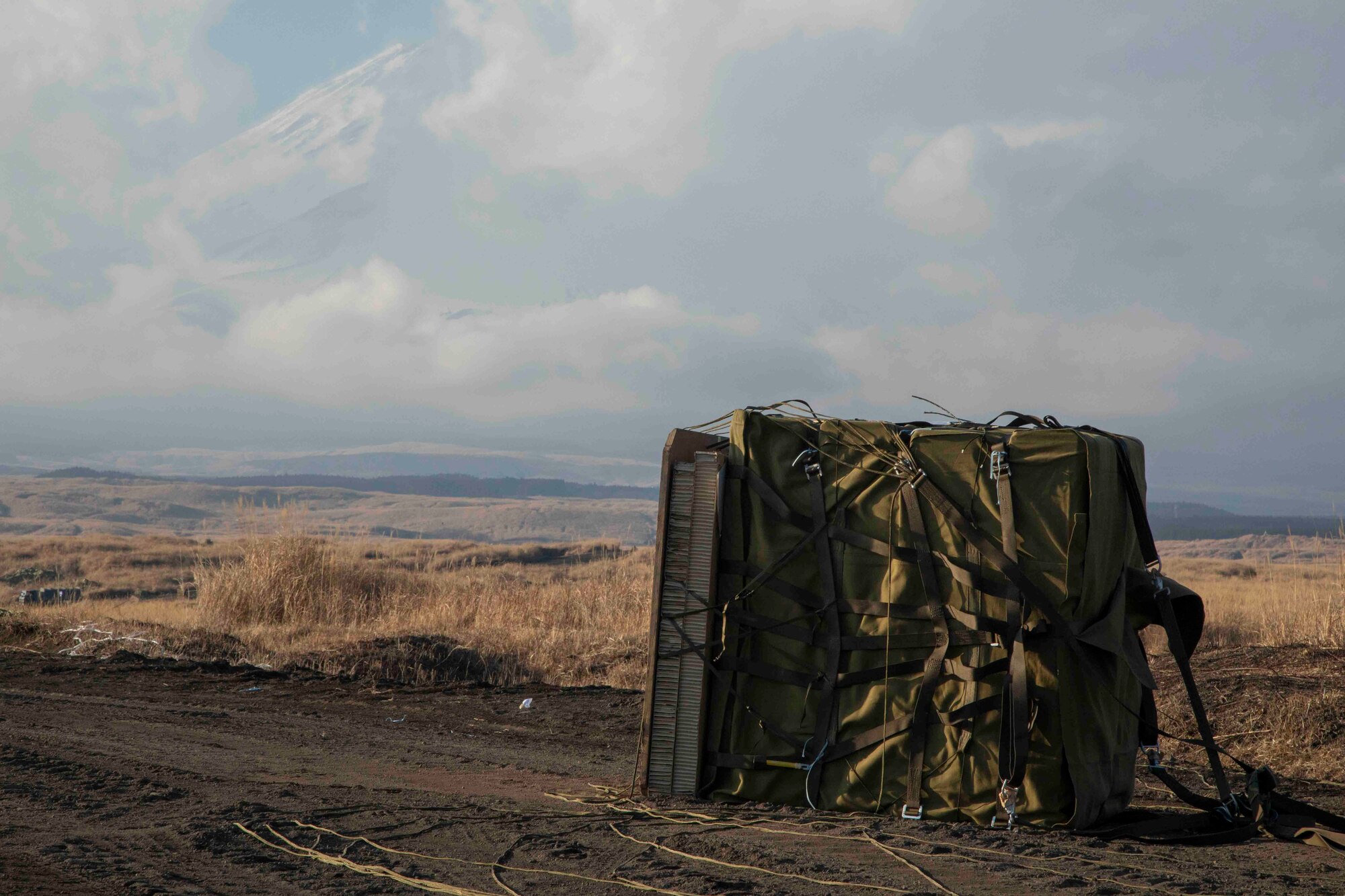 A container delivery system bundle sits in the drop zone at the Combined Arms Training Center, Camp Fuji, Japan, Jan. 26, 2022,