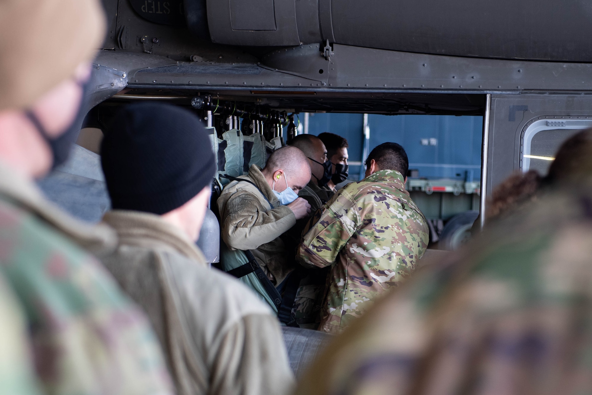 Airmen train how to properly buckle into a UH-60 Blackhawk