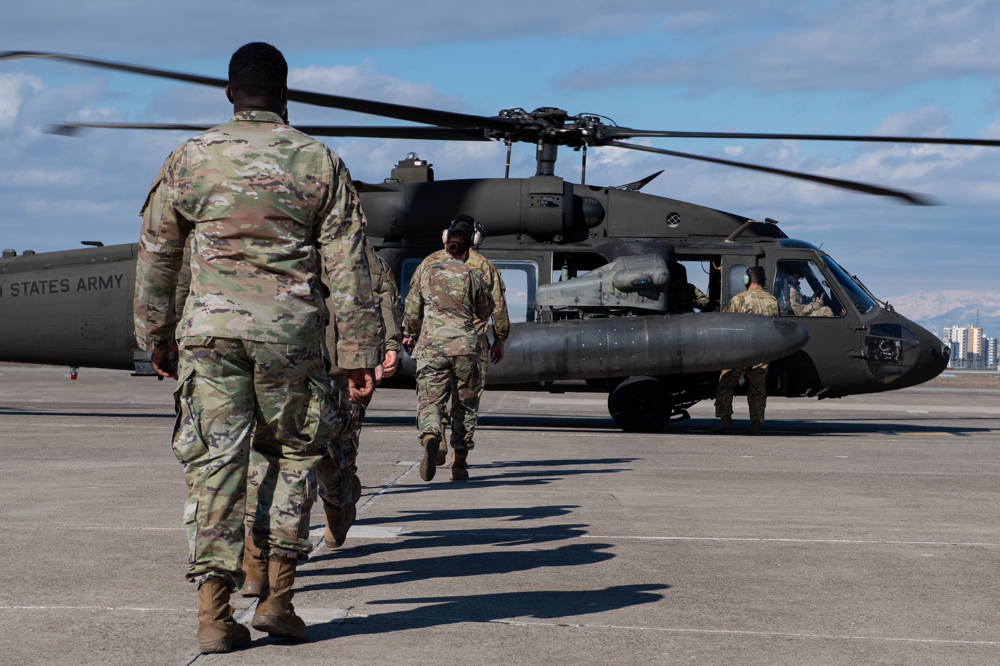 Airmen walk to UH-60 Blackhawk during a mission orientation
