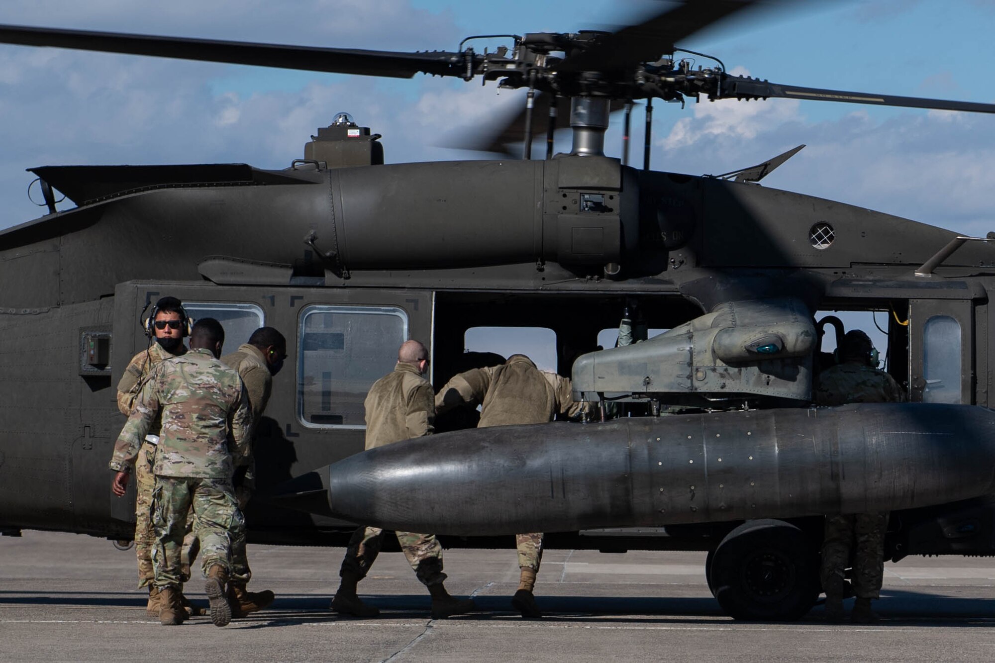 Airmen load into a UH-60 Blackhawk during a mission orientation