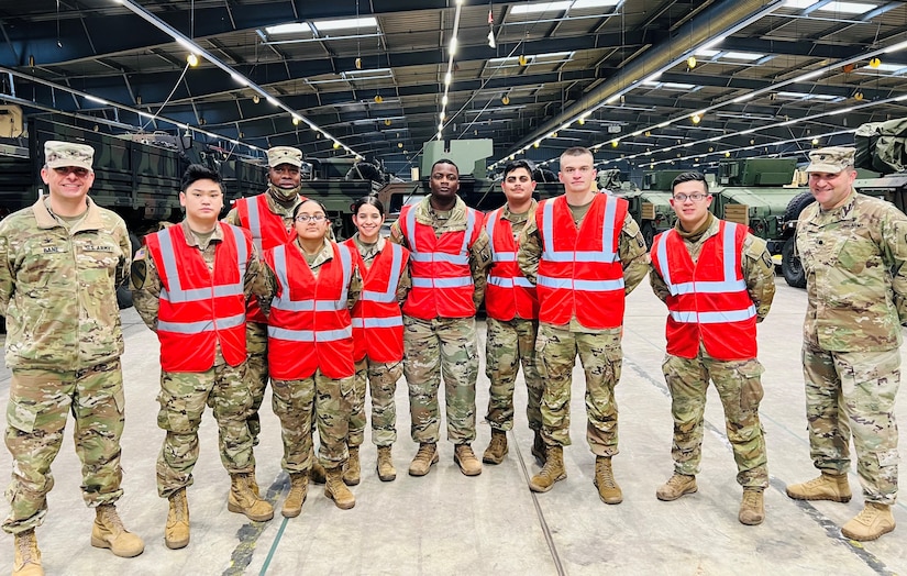 The 405th Army Field Support Brigade commander, Col. Brad Bane, and the Army Field Support Battalion-Benelux commander, Lt. Col. Aaron Jones, pose for a group photo with eight Soldier mechanics from B Company, 553rd Division Sustainment Support Battalion, 1st Cavalry Division Sustainment Brigade. The Fort Hood, Texas, Soldiers are attached to the 16th Sustainment Brigade, 21st Theater Sustainment Command while in Europe. They supported the 405th AFSB at its Army Prepositioned Stock-2 worksite in Eygelshoven, Netherlands recently, conducting 127 quality assurance inspections, 76 radio inspections and four inventories of shop equipment. They also repaired eight deadlined vehicles and brought 106 pieces of equipment up to safety code. (U.S. Army courtesy photo)