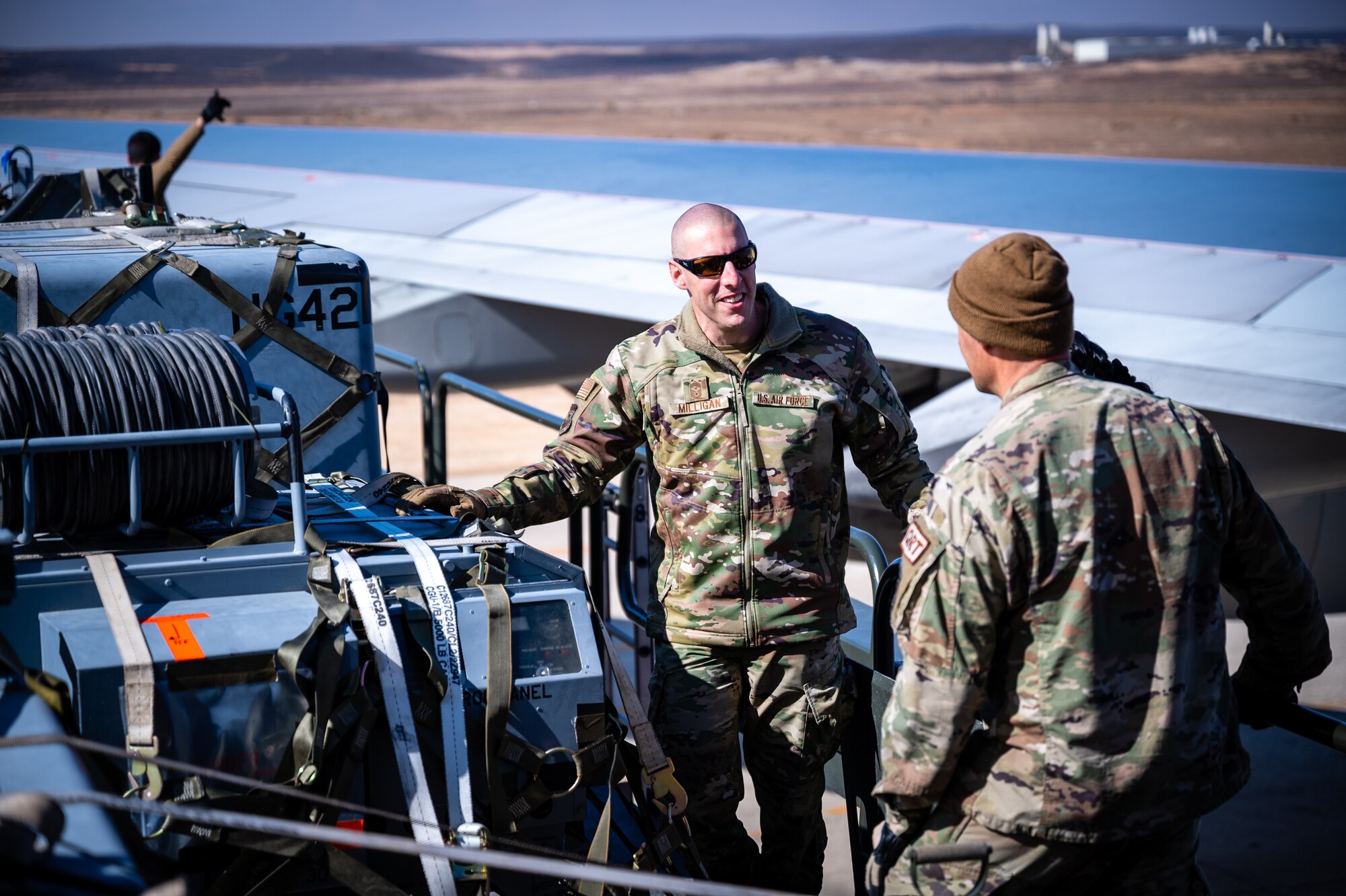 U.S. Air Force Chief Master Sgt. Sean M. Milligan, 332d Air Expeditionary Wing command chief, discusses cargo movement with a 332d Expeditionary Logistics Readiness Squadron Airman during an immersion visit in Southwest Asia, Jan. 29, 2022. Chief Milligan's immersion visits give him a better understanding of the unique skillsets every Airman brings to the 332d AEW Red Tail team. (U.S. Air Force photo by Master Sgt. Christopher Parr)